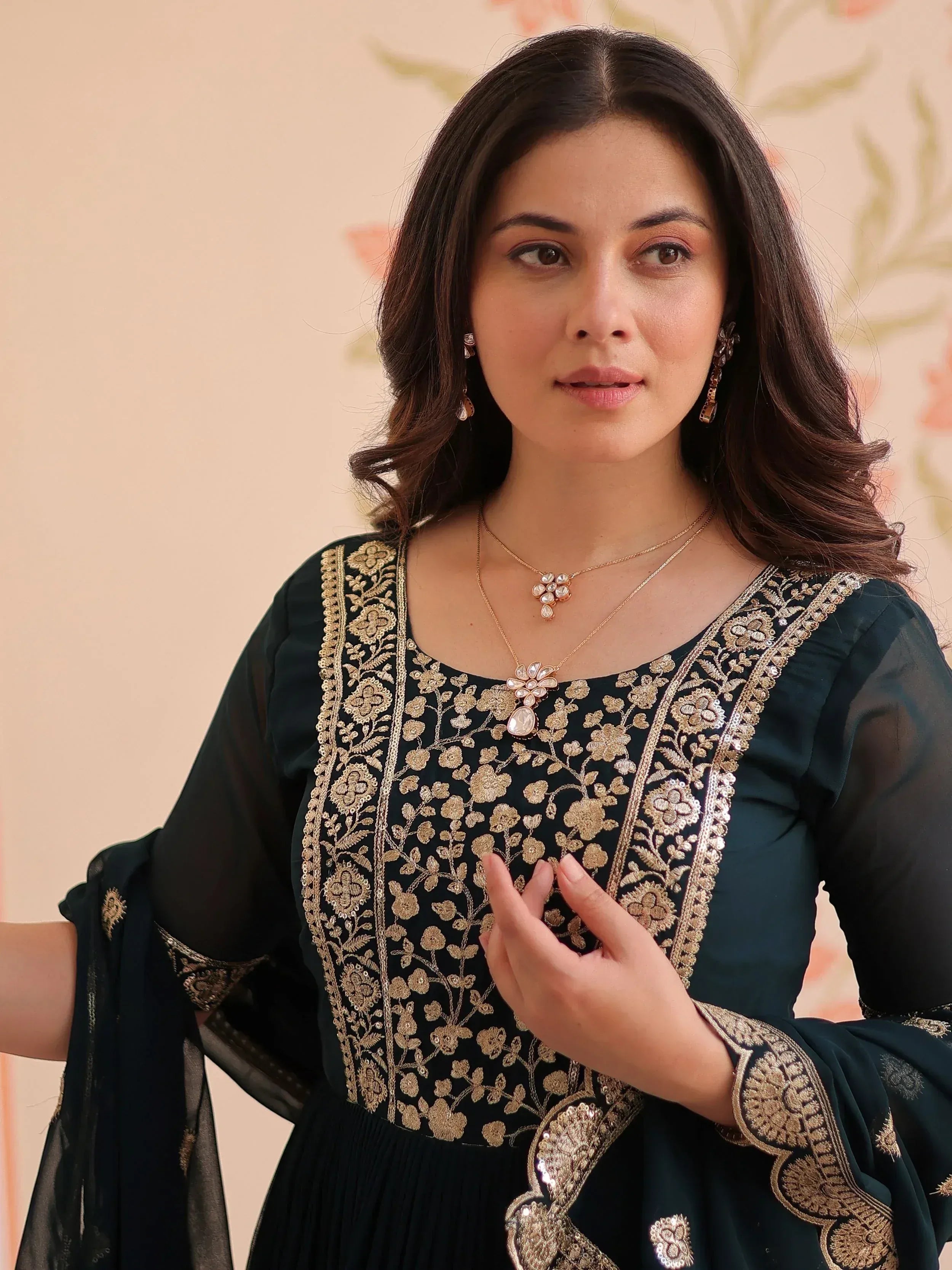 Elegant black ethnic gown with gold floral embroidery, perfect for Indian occasions