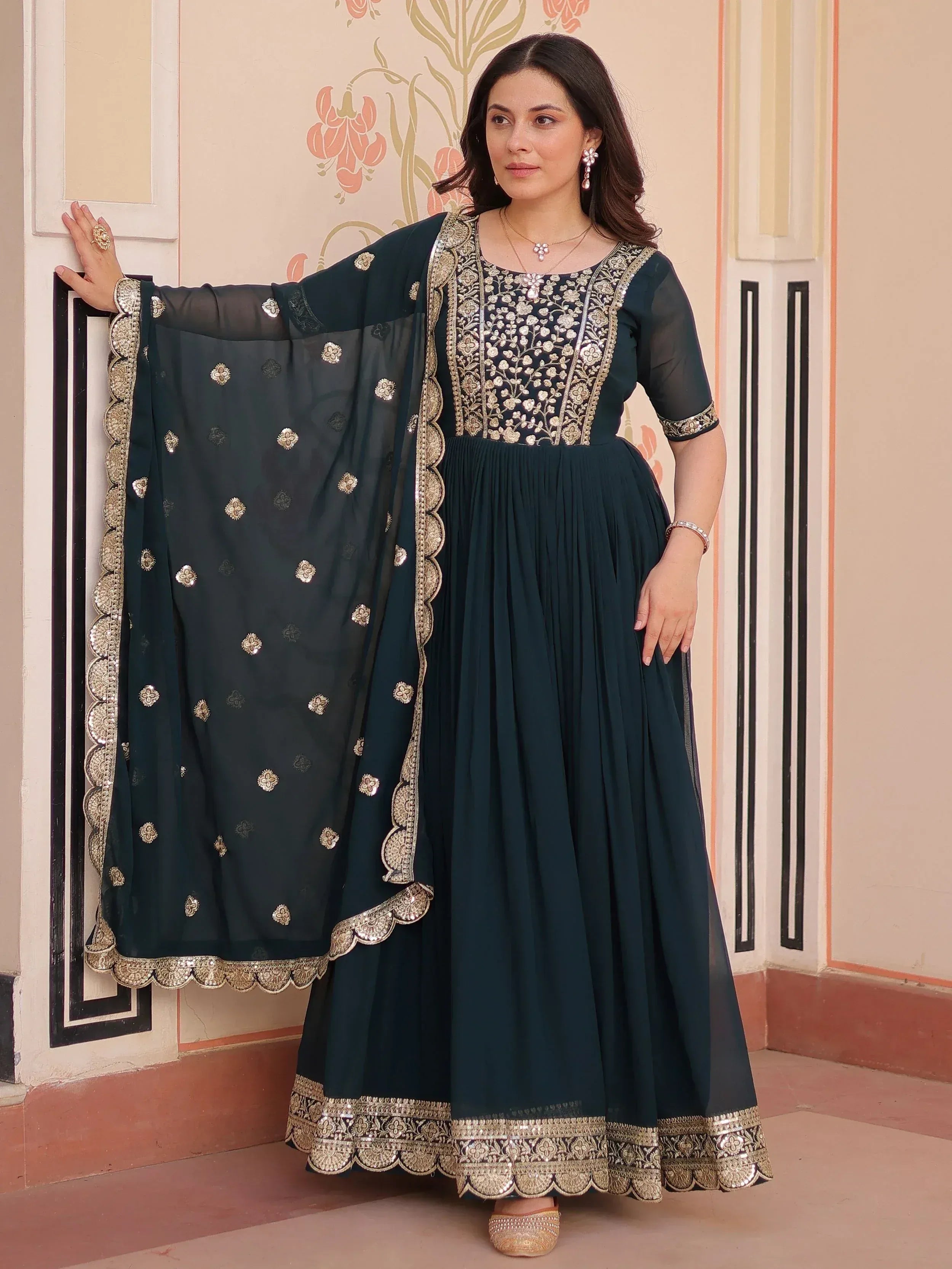 Dark green embroidered anarkali suit with gold detailing and matching dupatta, ideal for Indian ethnic occasions.