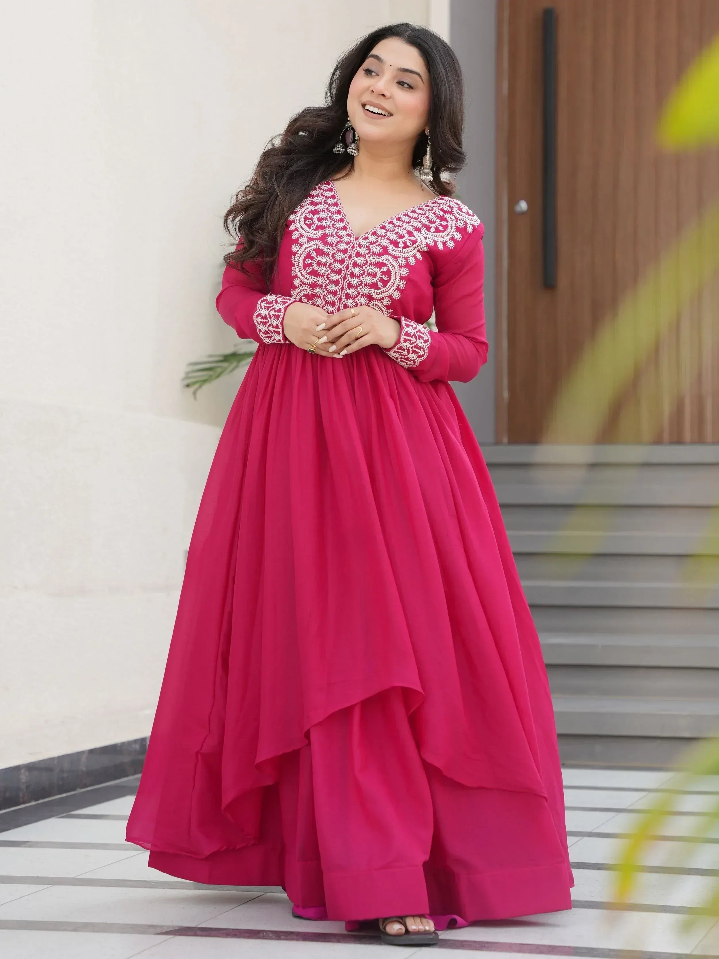 Pink ethnic gown with white embroidery, long sleeves, and flared skirt for women