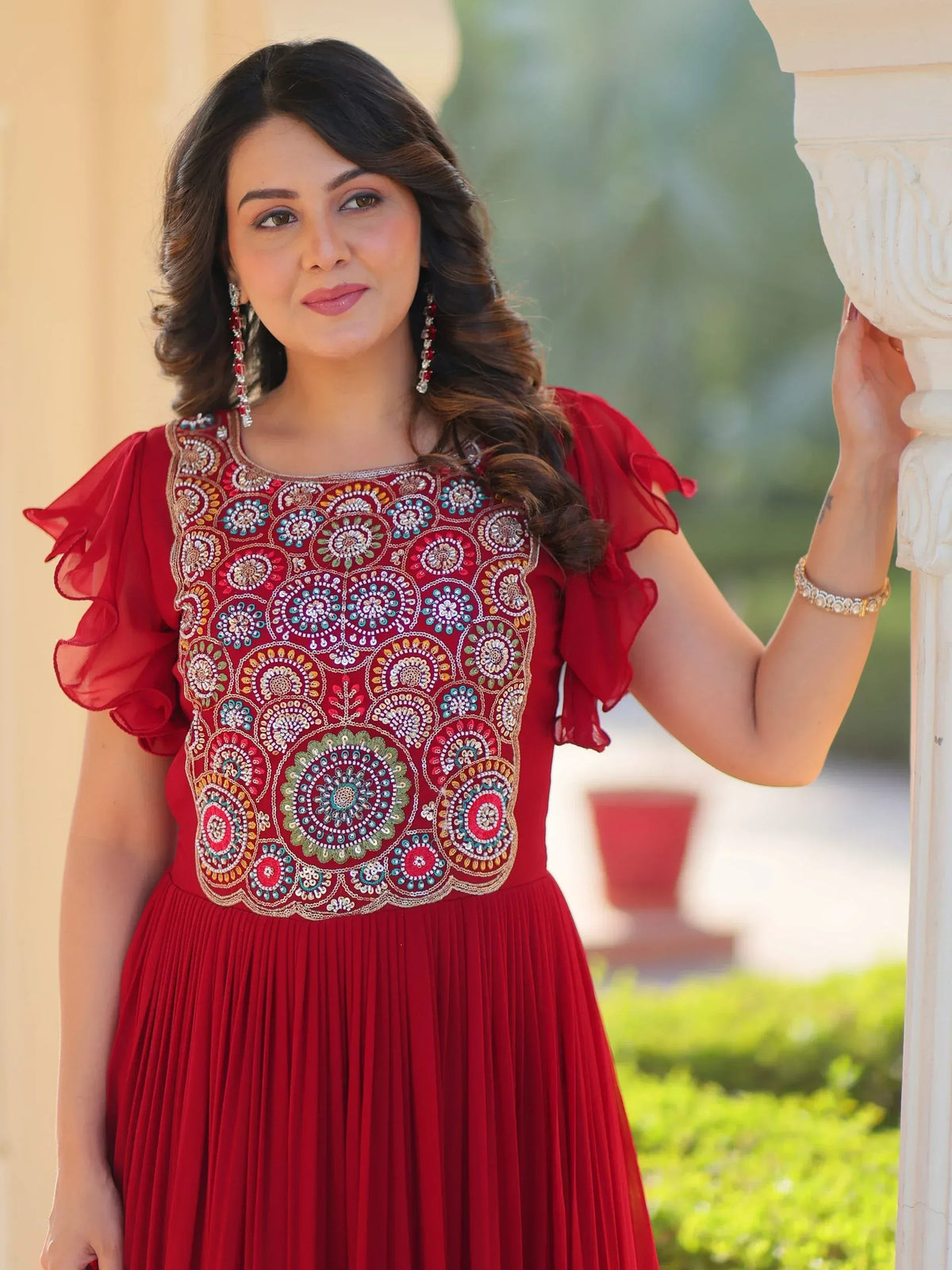 Red ethnic gown with floral embroidery and ruffled sleeves for festive occasions