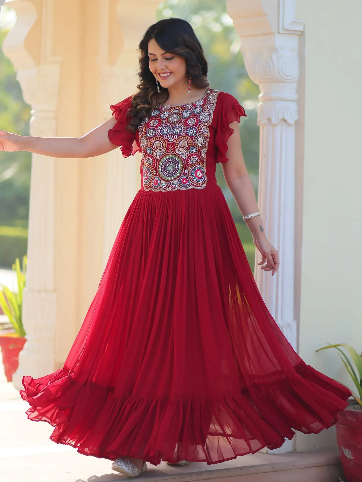 Red ethnic gown with floral embroidery and ruffled sleeves for festive occasions
