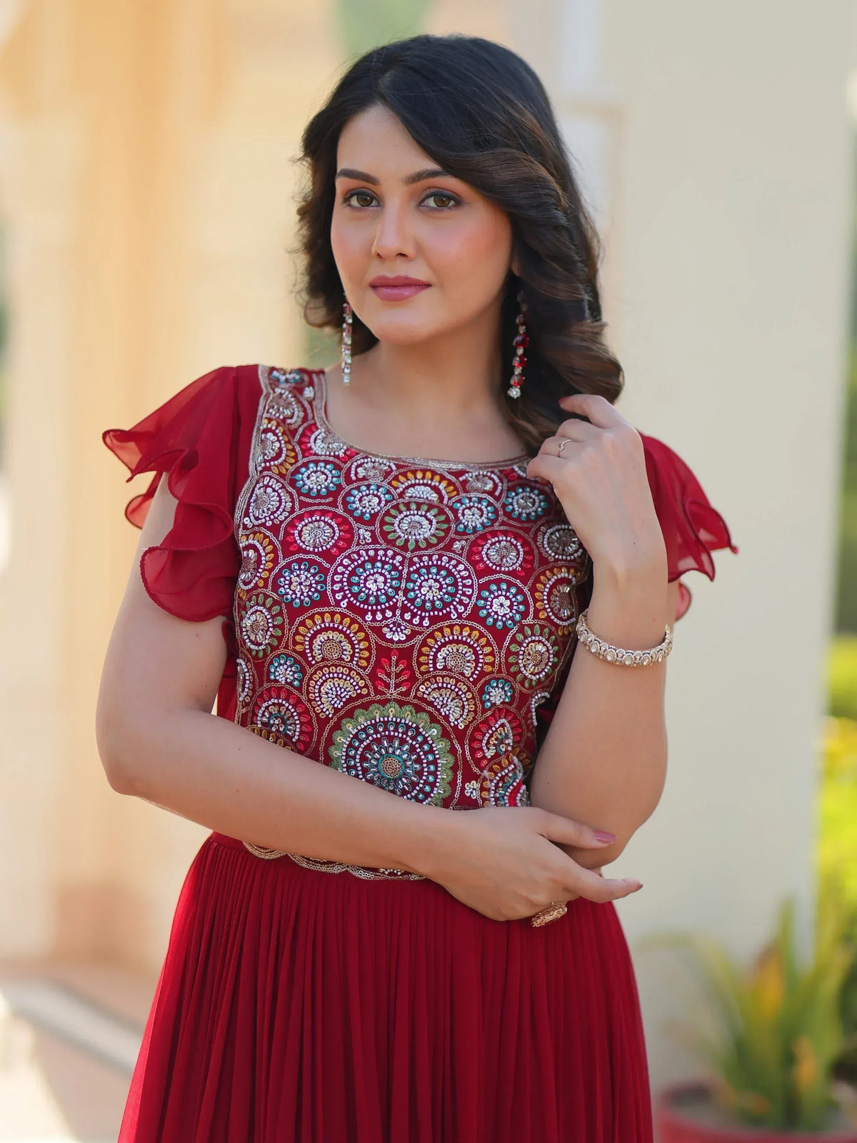 Red embroidered ethnic gown with ruffled sleeves and floral patterns