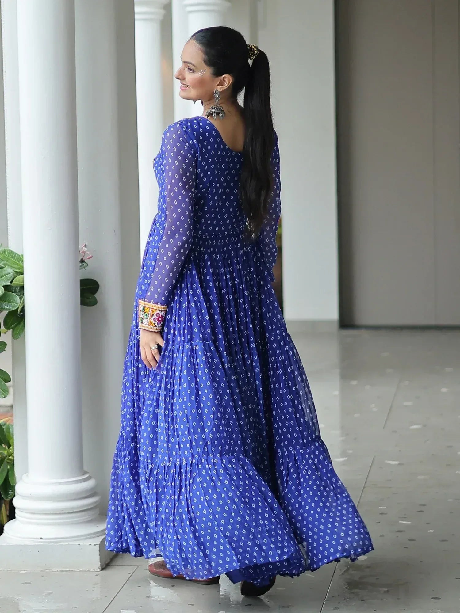Blue printed ethnic gown with embroidered sleeves, perfect for Indian occasions and festive wear.
