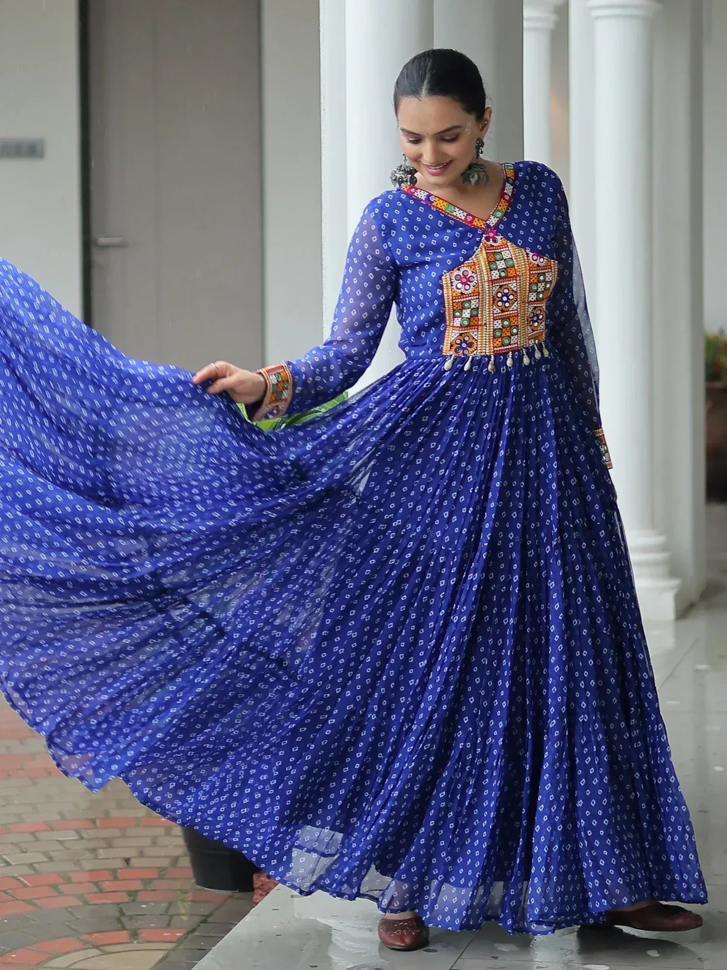 Woman in blue printed ethnic gown with colorful embroidery, perfect for festive occasions