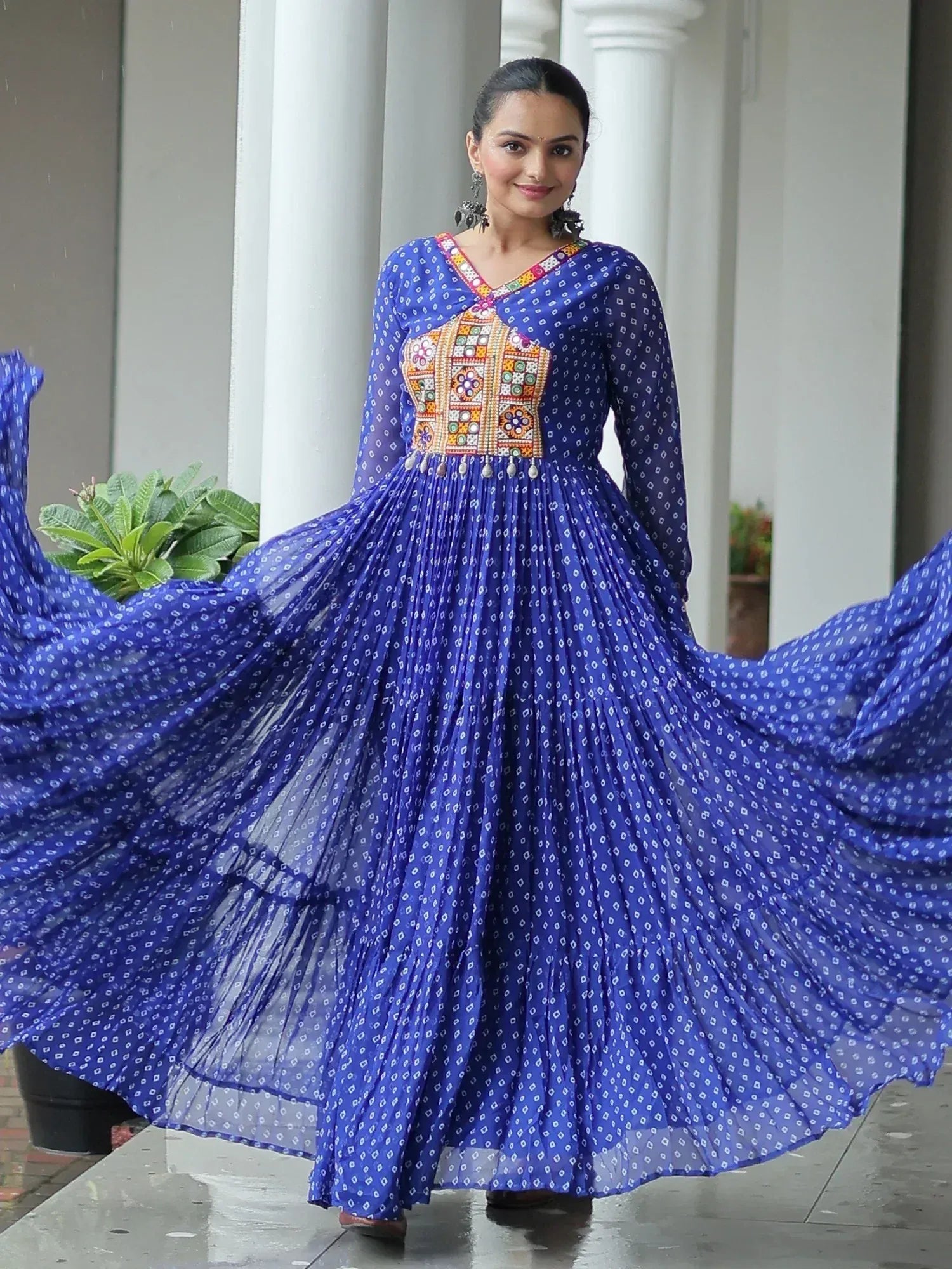 Blue ethnic gown with mirror work and printed pleats, perfect for festive occasions