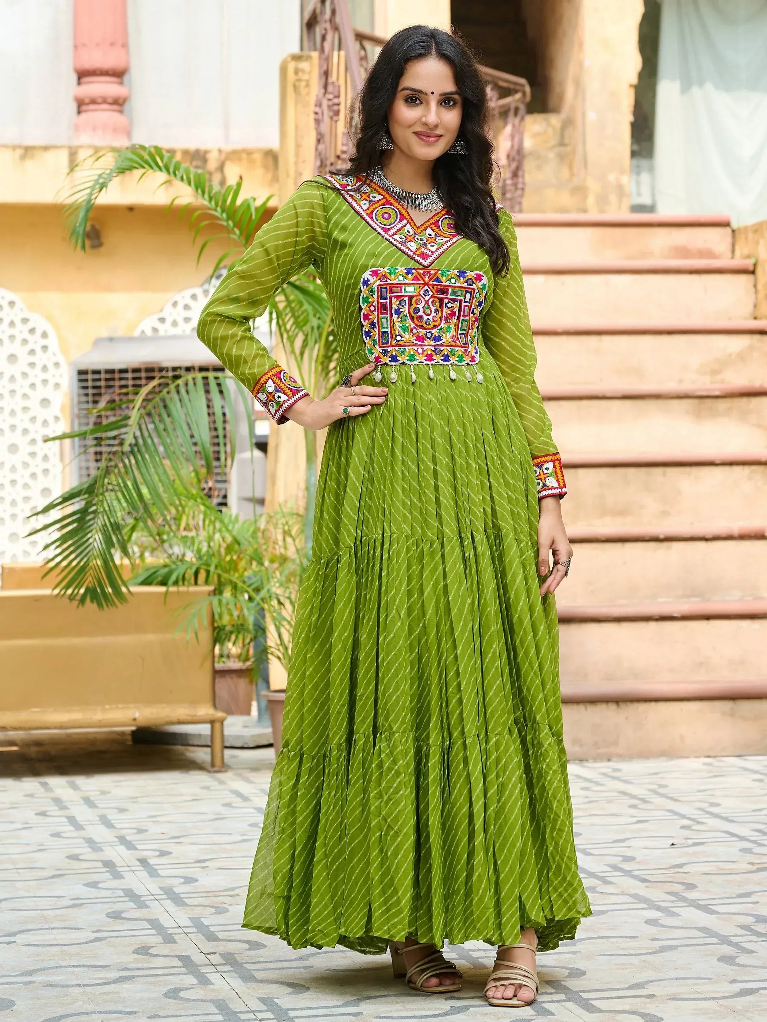 Green ethnic gown with colorful mirror work, perfect for Indian festive occasions and traditional events.