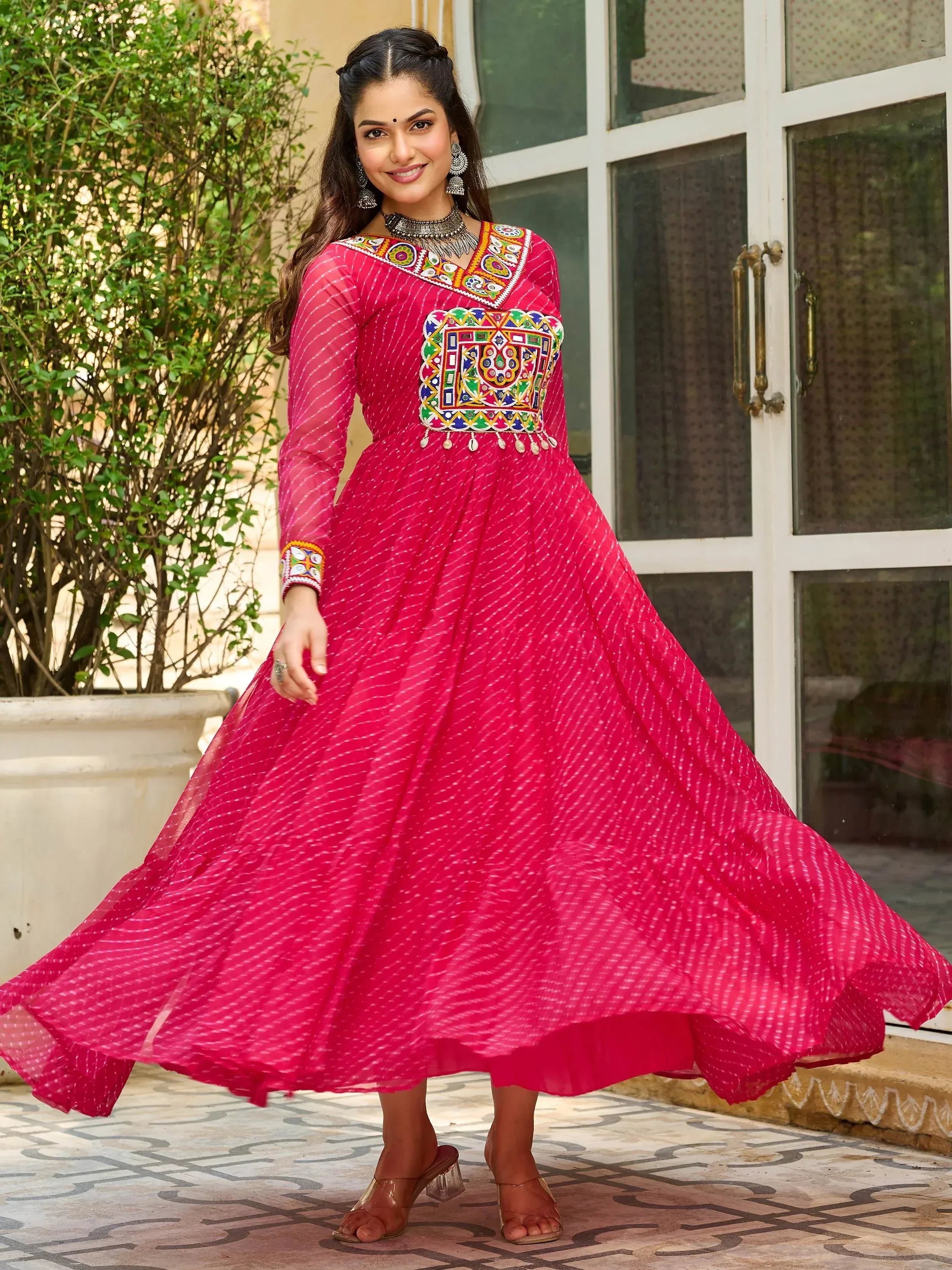 Pink ethnic gown with colorful mirror work and embroidery, perfect for Indian festive occasions