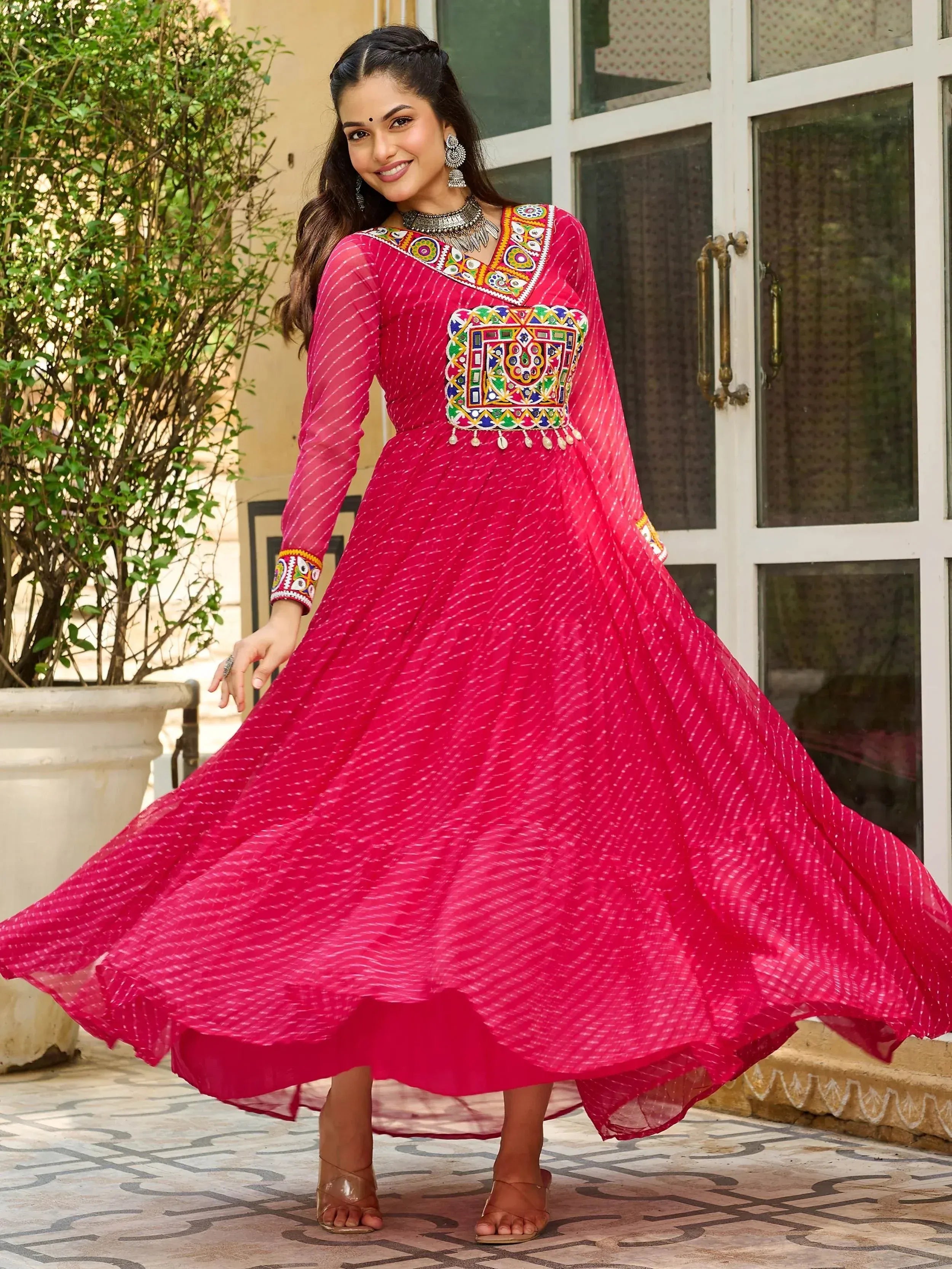 Pink ethnic gown with mirror work and embroidery, perfect for Indian occasions