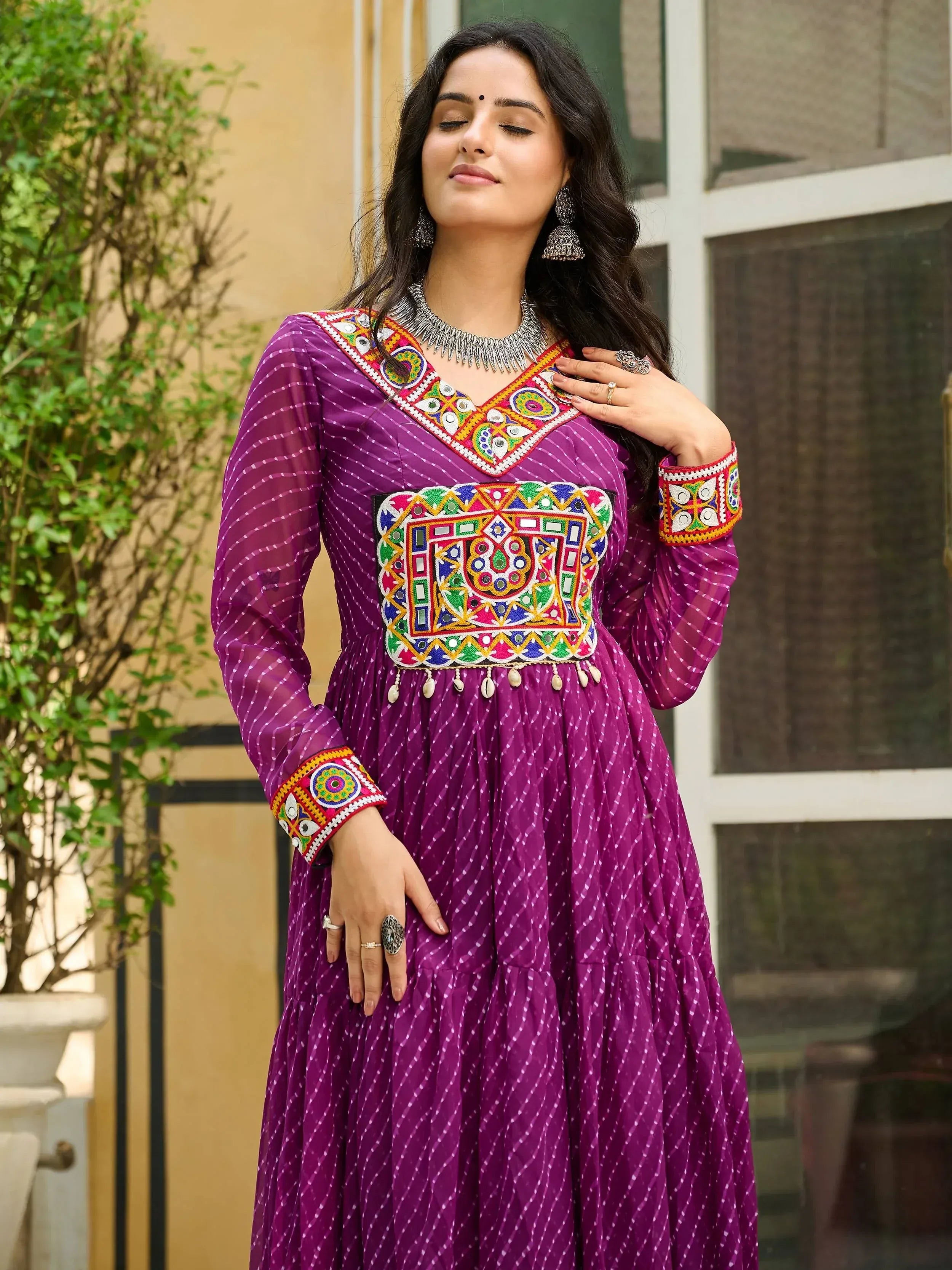 Purple ethnic gown with colorful mirror work and embroidery, perfect for Indian festive occasions