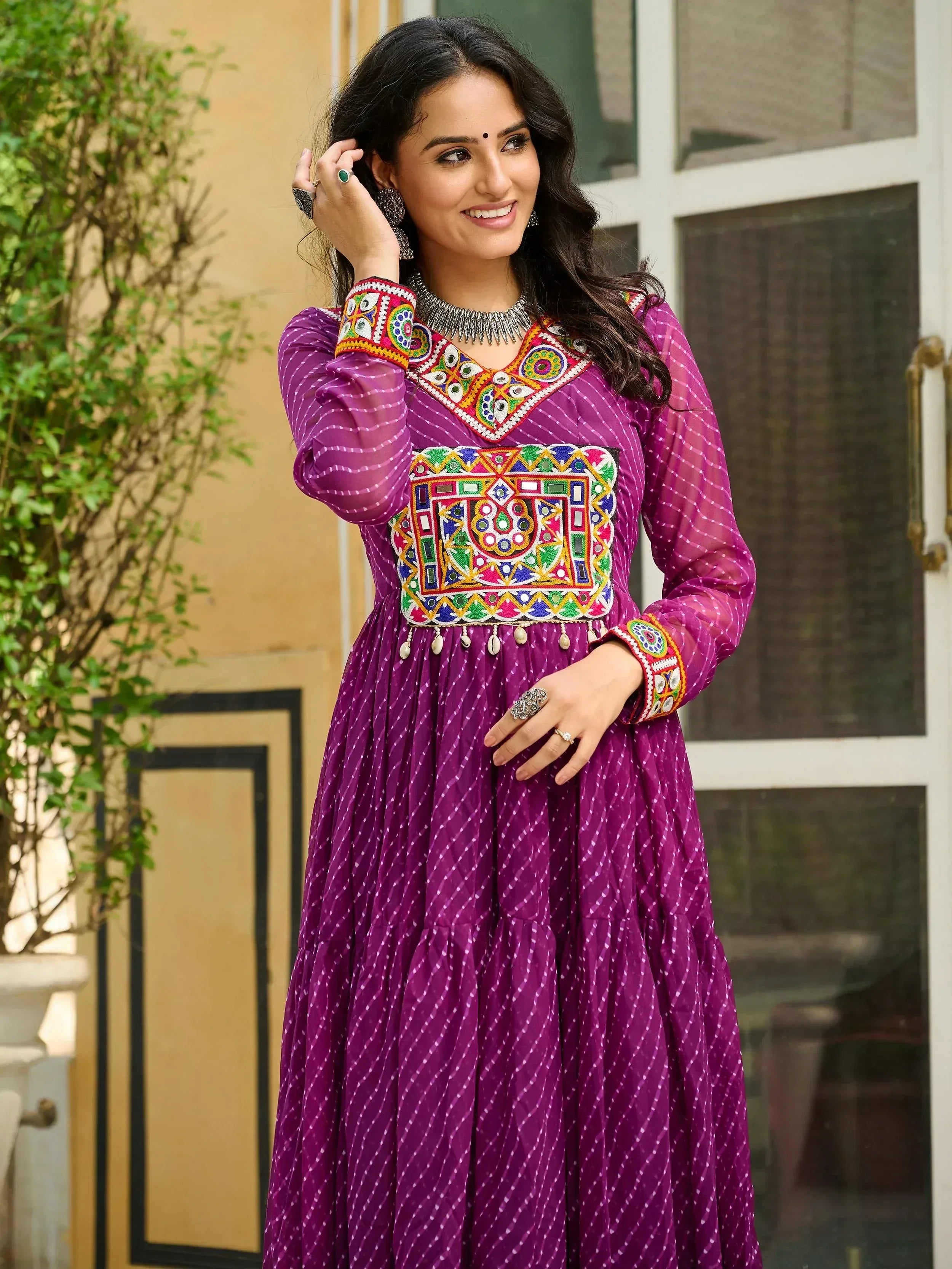 Purple ethnic gown with colorful mirror work and embroidery, perfect for Indian festive occasions
