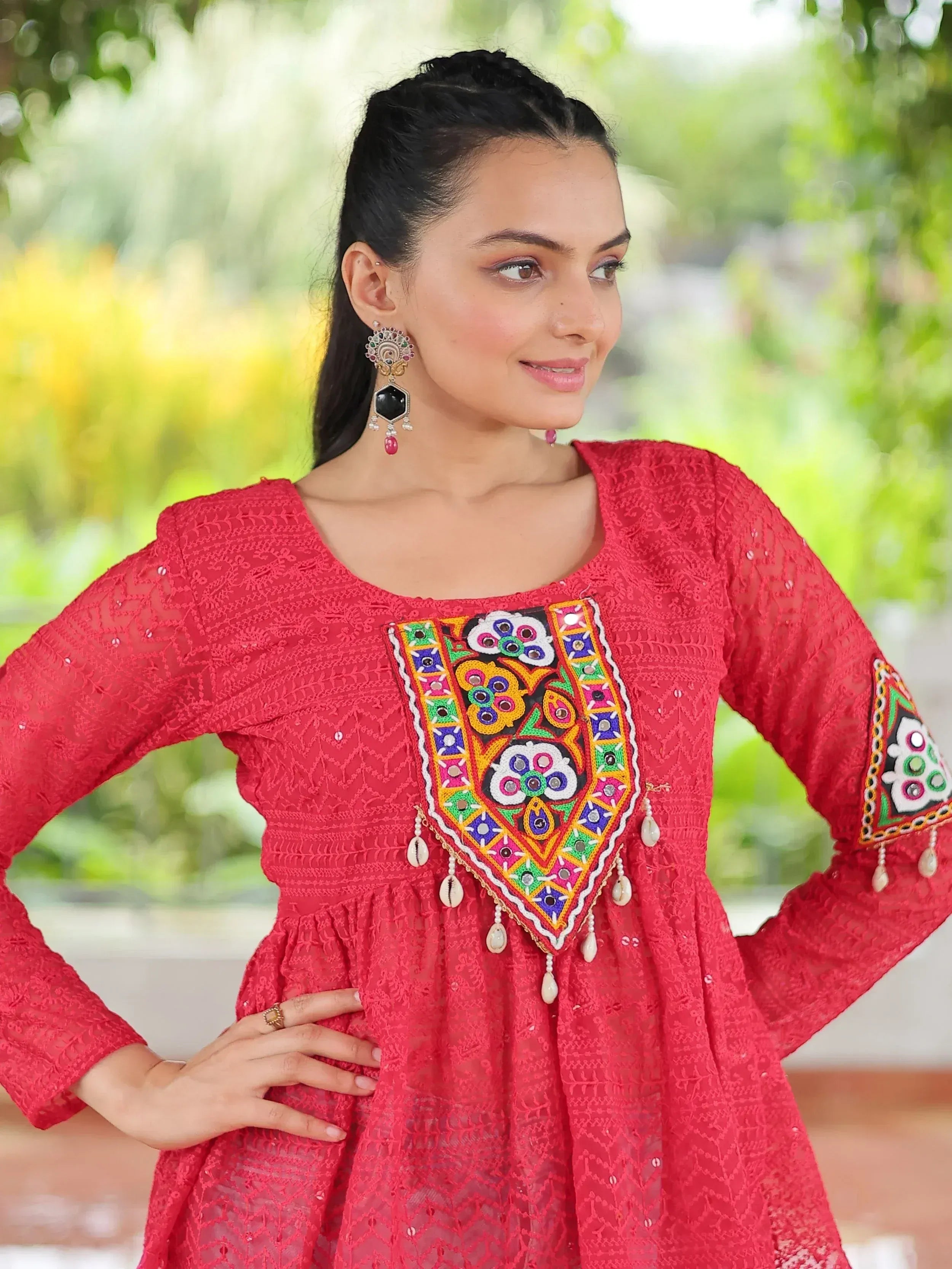 Red embroidered ethnic kurta with mirror work and tassels, perfect for festive occasions.