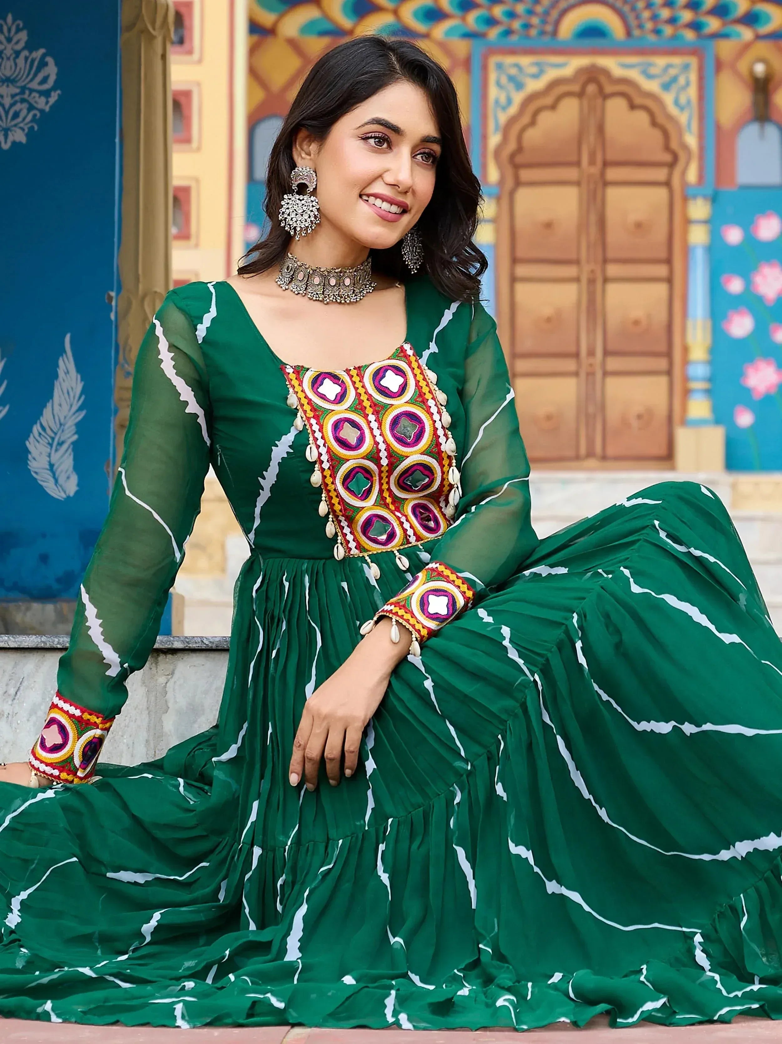 Green ethnic gown with colorful embroidery and mirror work, perfect for Indian festive occasions