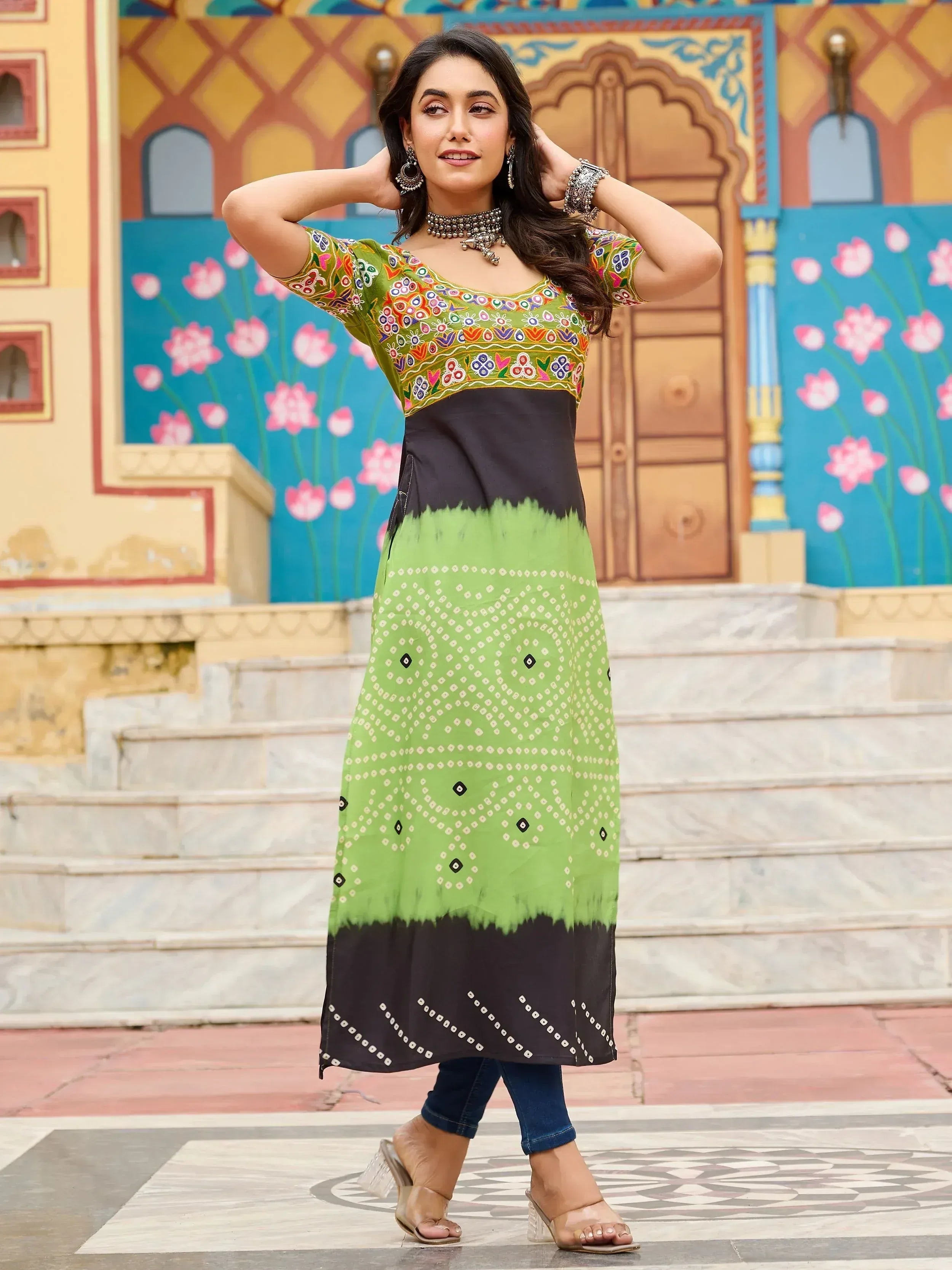 Green and black embroidered ethnic kurti with tie-dye print, paired with jeans for a fusion look