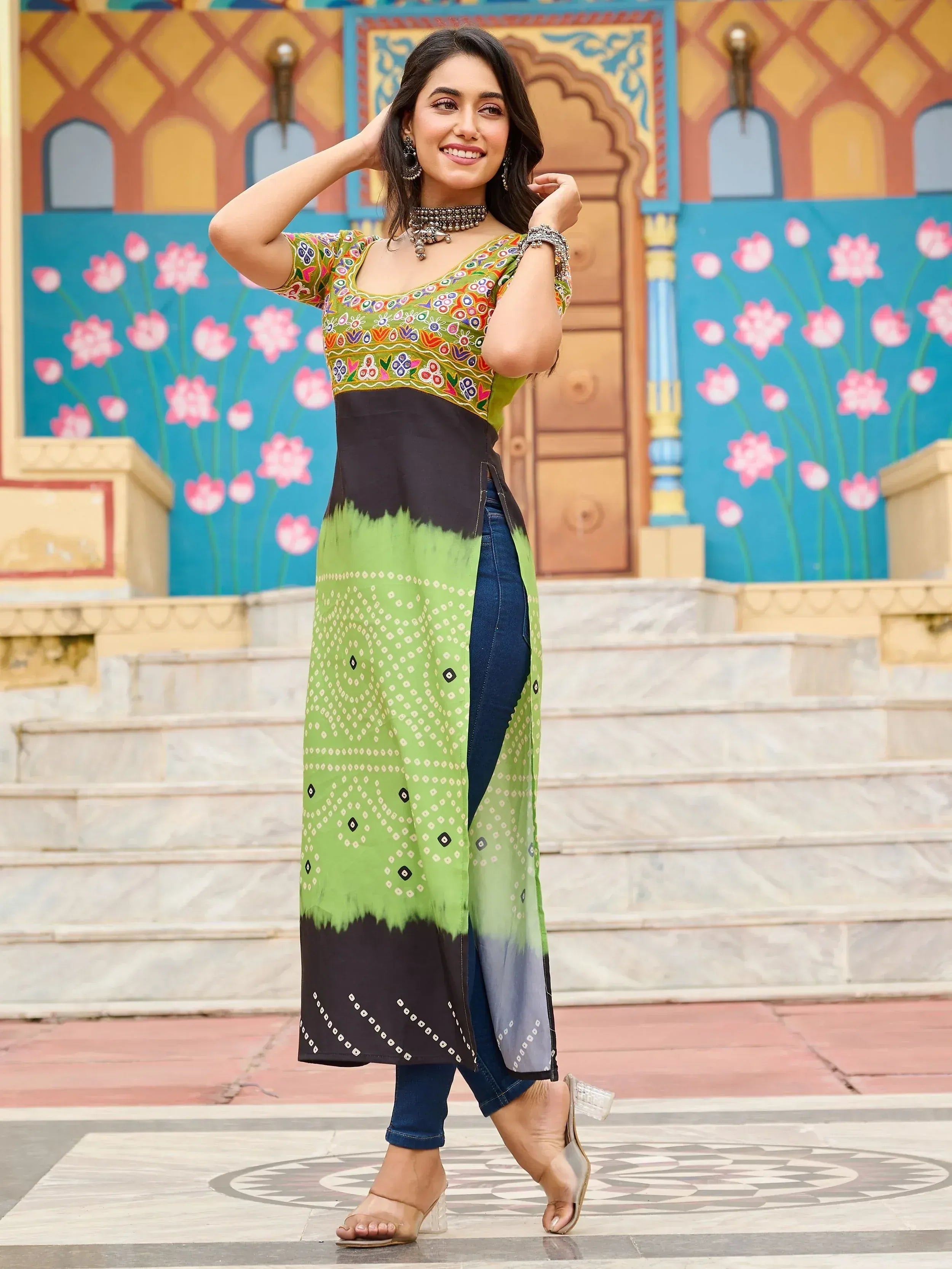 Woman in green and black printed ethnic kurti with denim jeans, perfect for Indian festive wear
