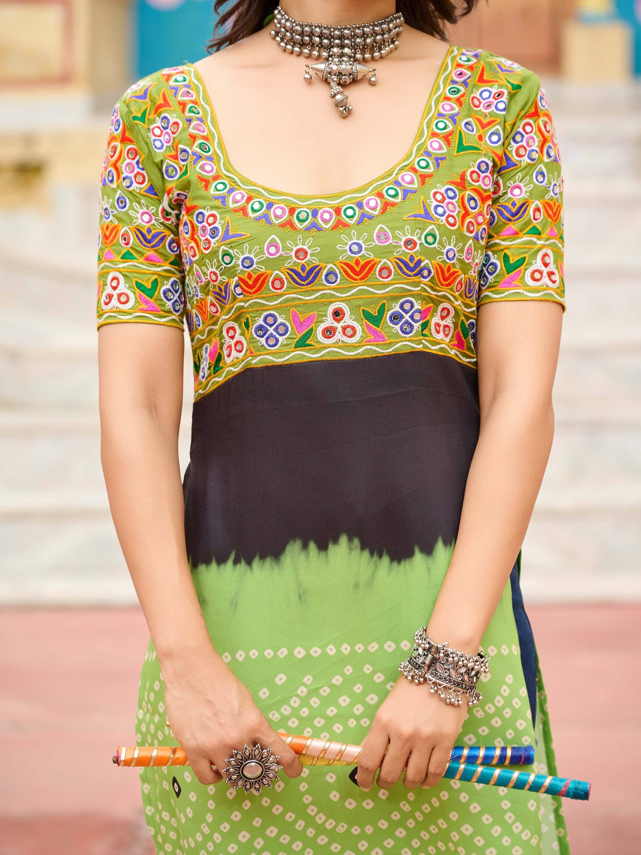 Green embroidered ethnic kurti with black panel and traditional jewelry
