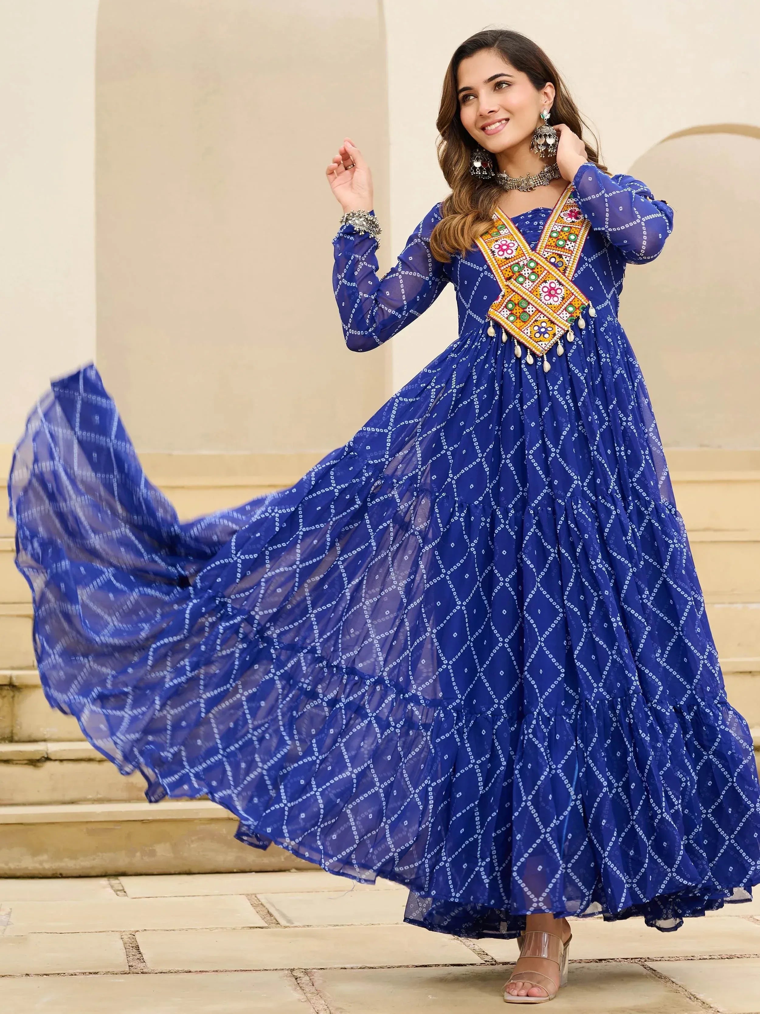 Blue ethnic gown with mirror work and bandhani print, perfect for Indian occasions