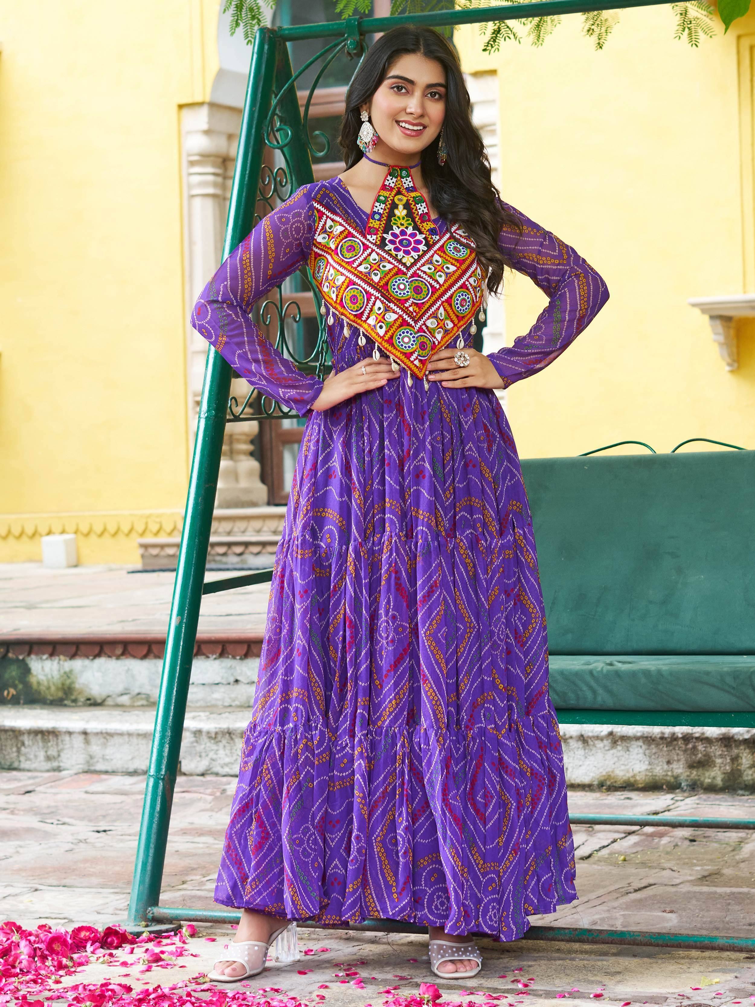 Purple ethnic gown with vibrant mirror work and printed patterns, perfect for Indian festive wear.