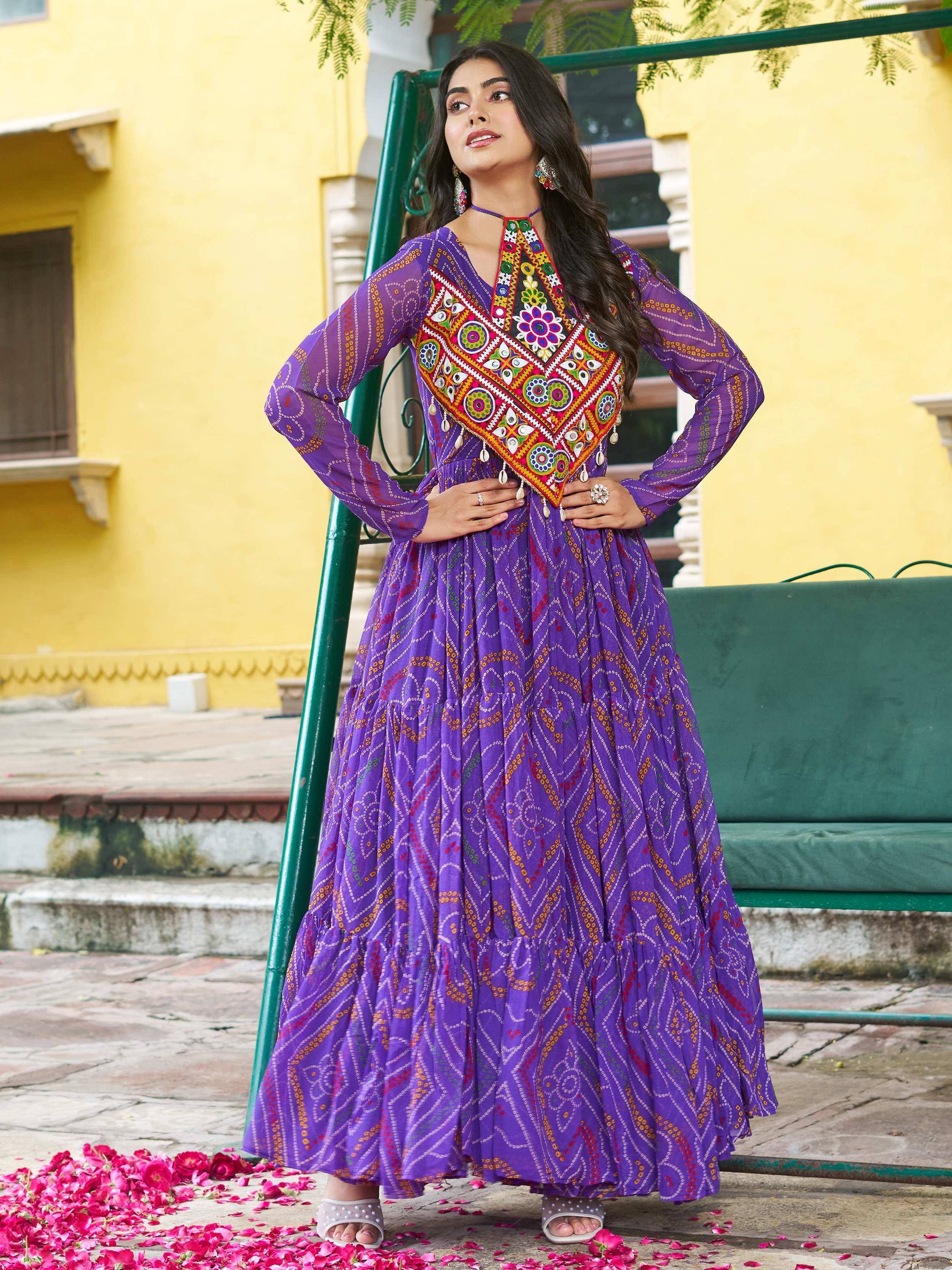 Purple ethnic gown with colorful mirror work and floral embroidery, perfect for Indian occasions