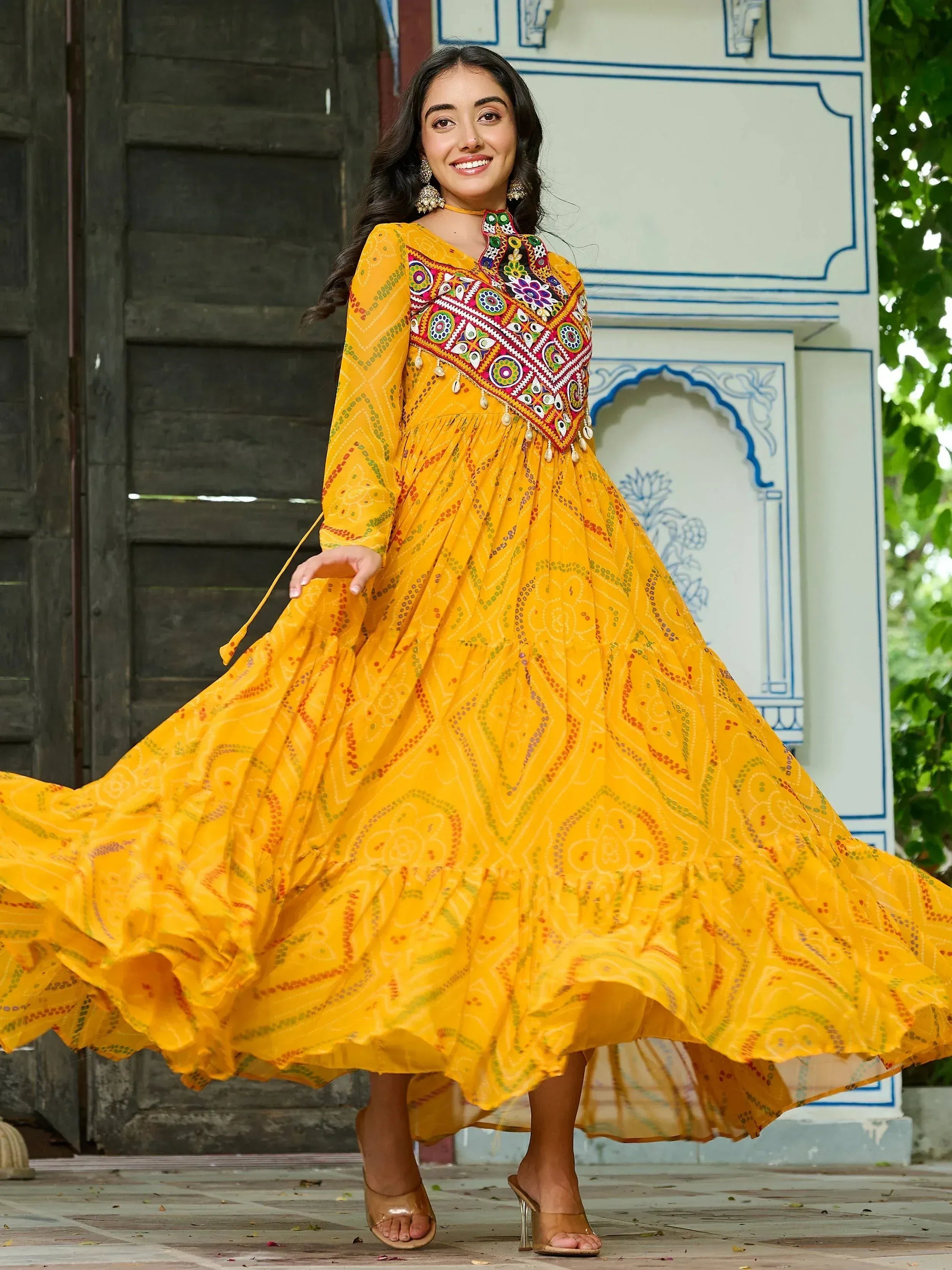 Yellow ethnic gown with colorful embroidery, perfect for Indian festive wear and designer occasions.