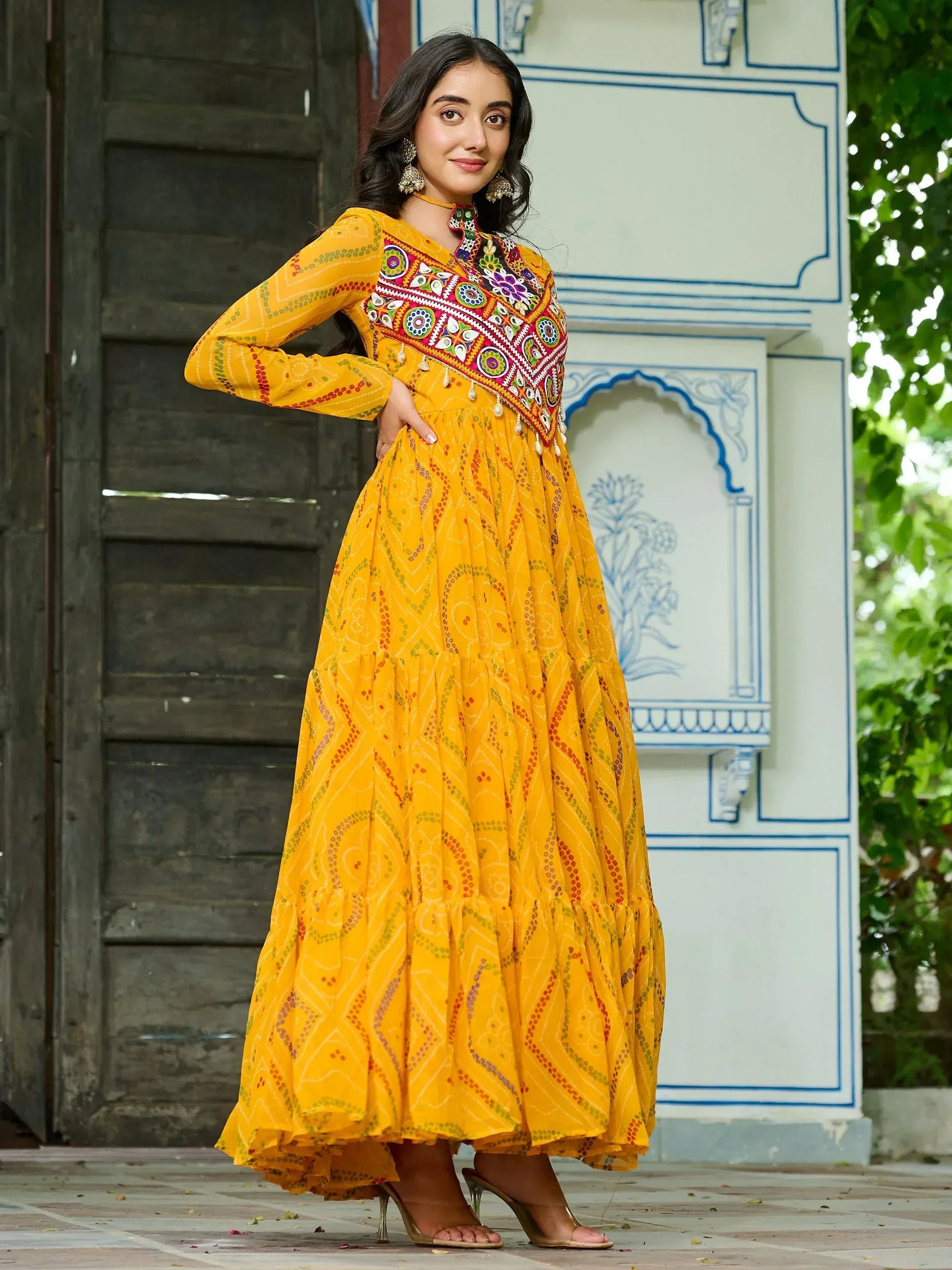 Yellow embroidered ethnic gown with mirror work, perfect for Indian festive occasions and parties.