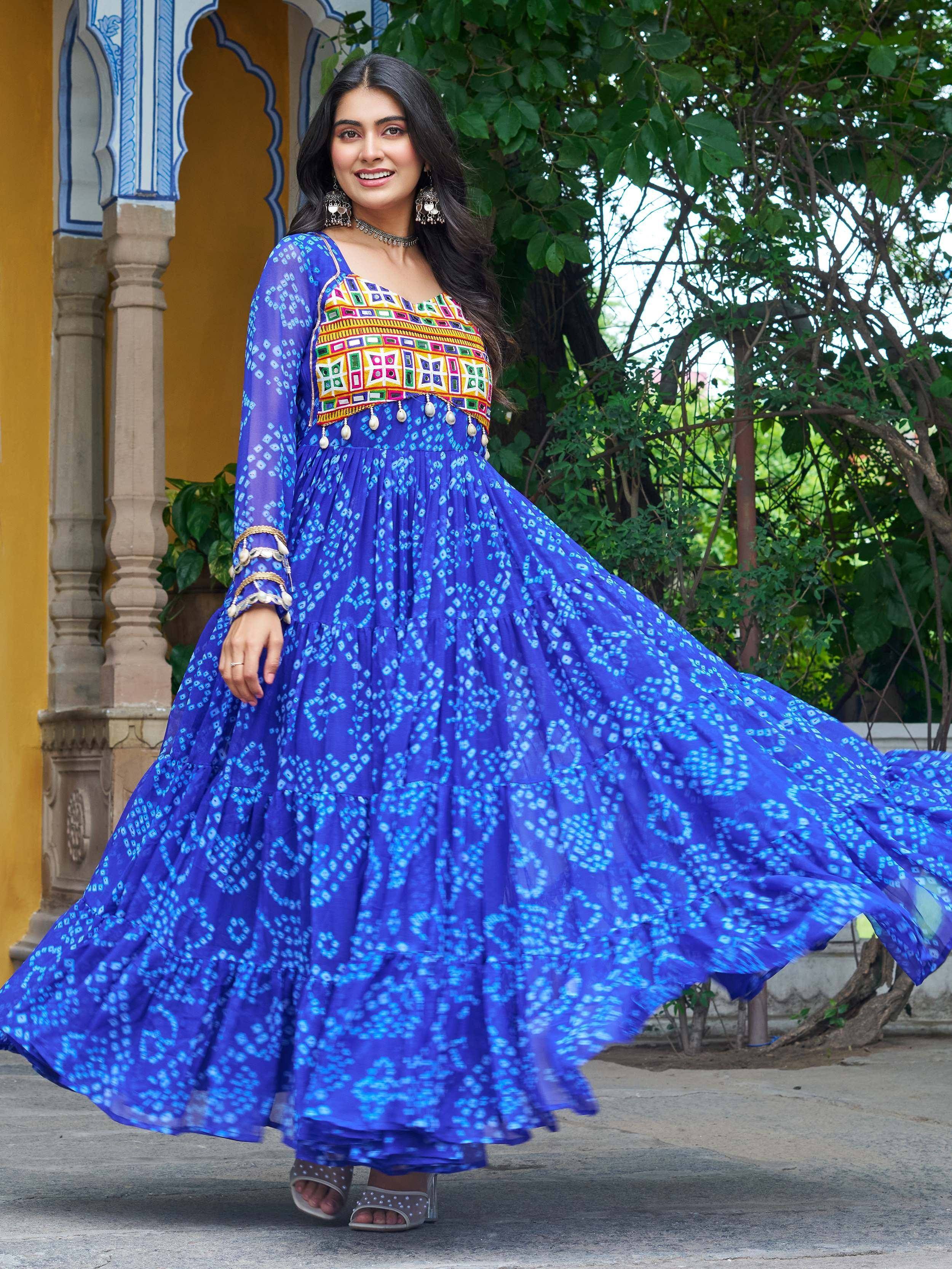 Woman in vibrant blue ethnic gown with colorful embroidery, perfect for Indian festive occasions