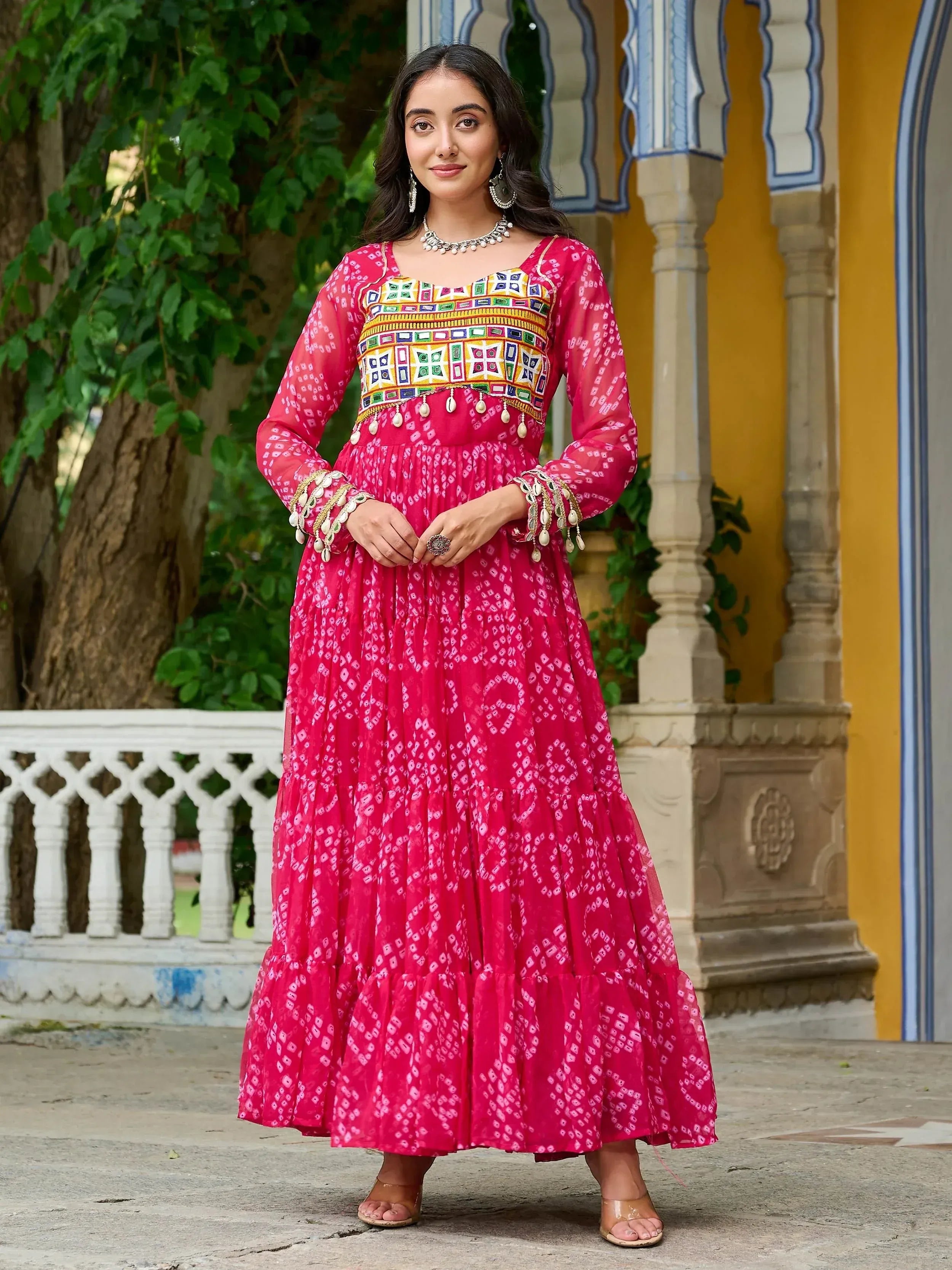 Pink ethnic gown with mirror work and bandhani print, perfect for Indian occasions