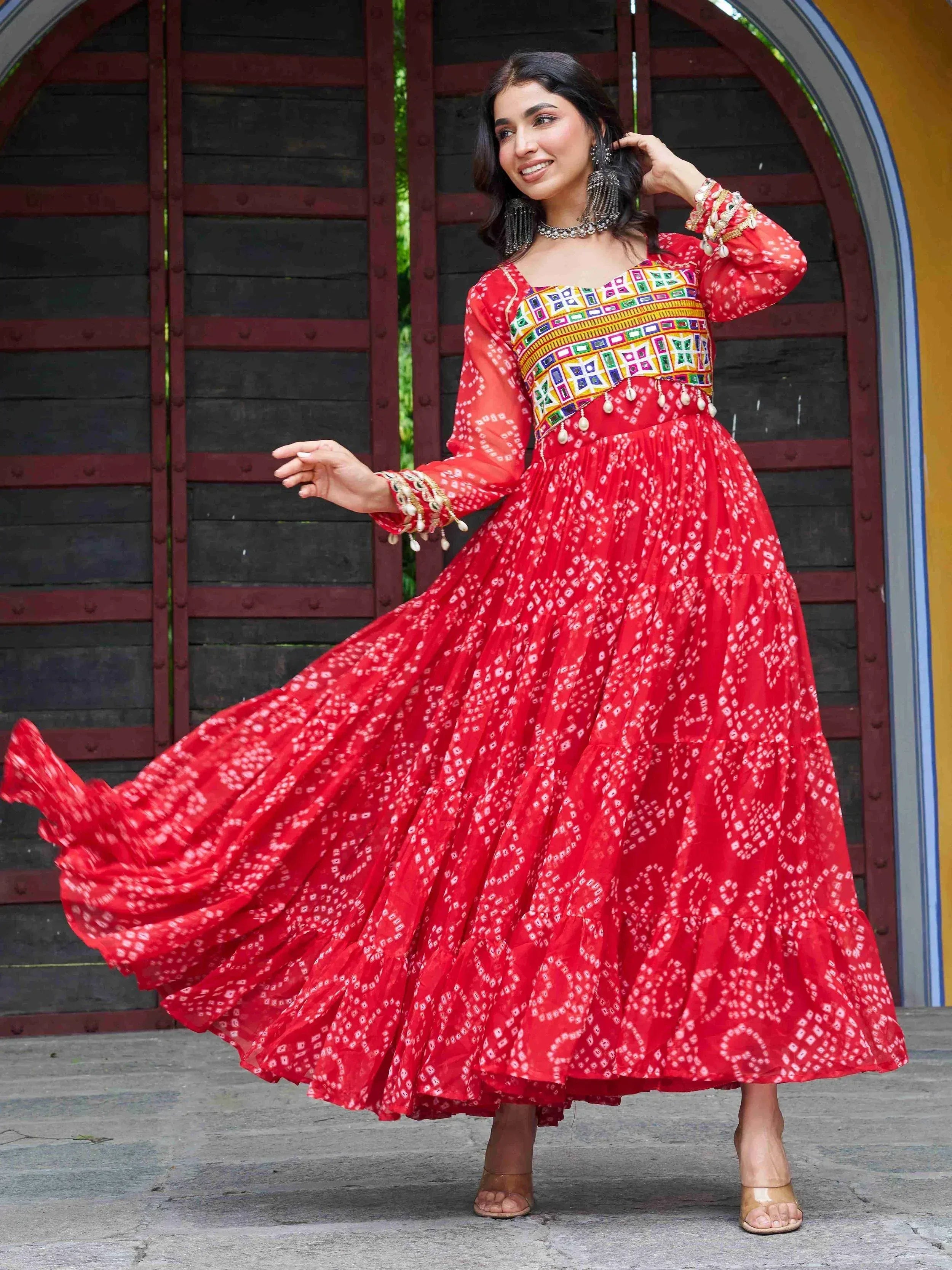 Red printed ethnic gown with colorful embroidery, perfect for Indian festive wear and designer occasions.