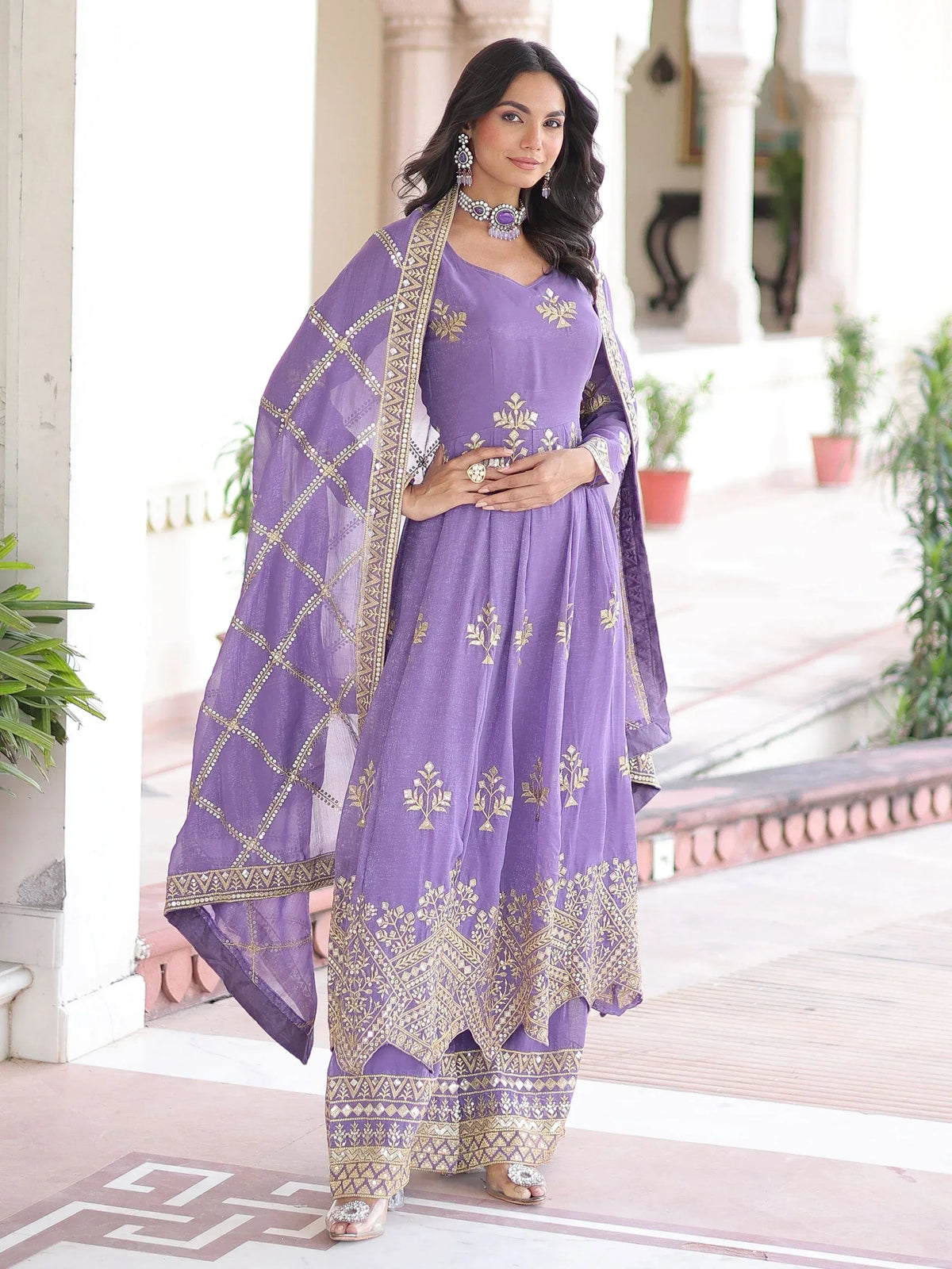 Purple embroidered Anarkali suit with gold detailing and matching dupatta, perfect for Indian ethnic occasions
