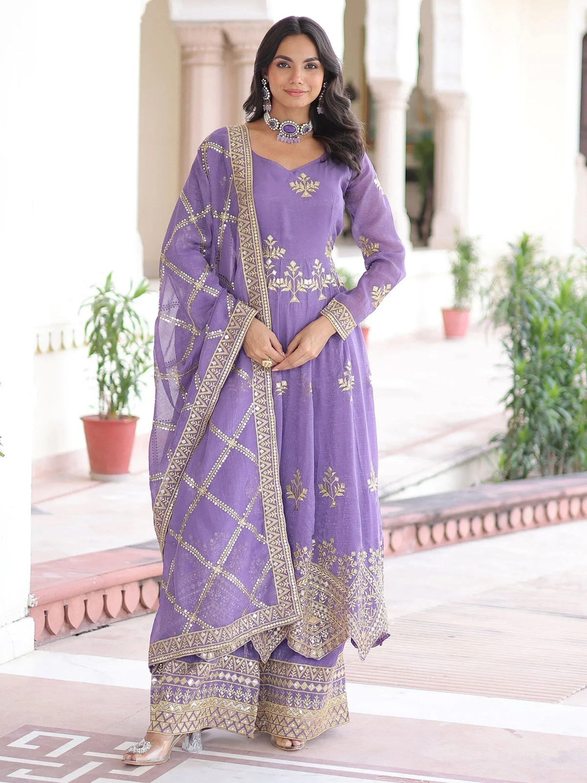 Purple embroidered salwar kameez with gold detailing, perfect for ethnic occasions