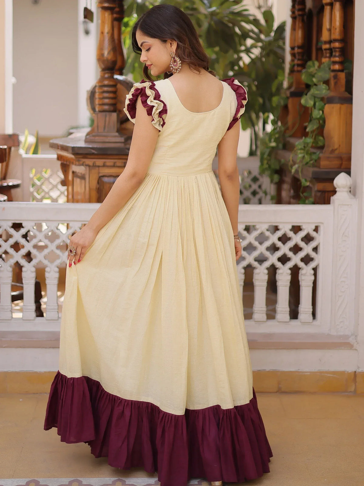 Cream and maroon ethnic gown with ruffled sleeves and hem, perfect for Indian occasions