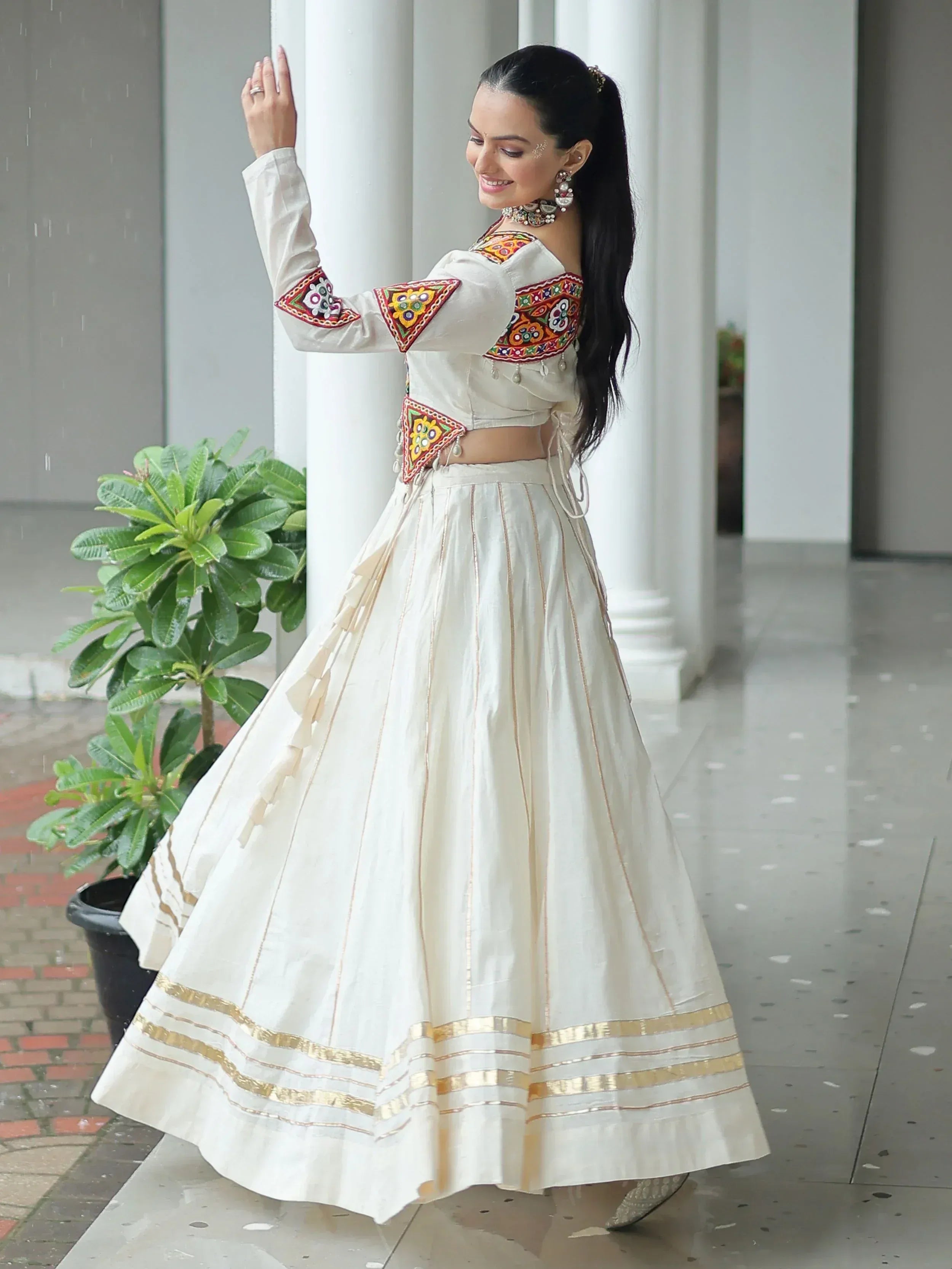 White embroidered lehenga choli with gold trim, perfect for Indian ethnic wear and festive occasions.