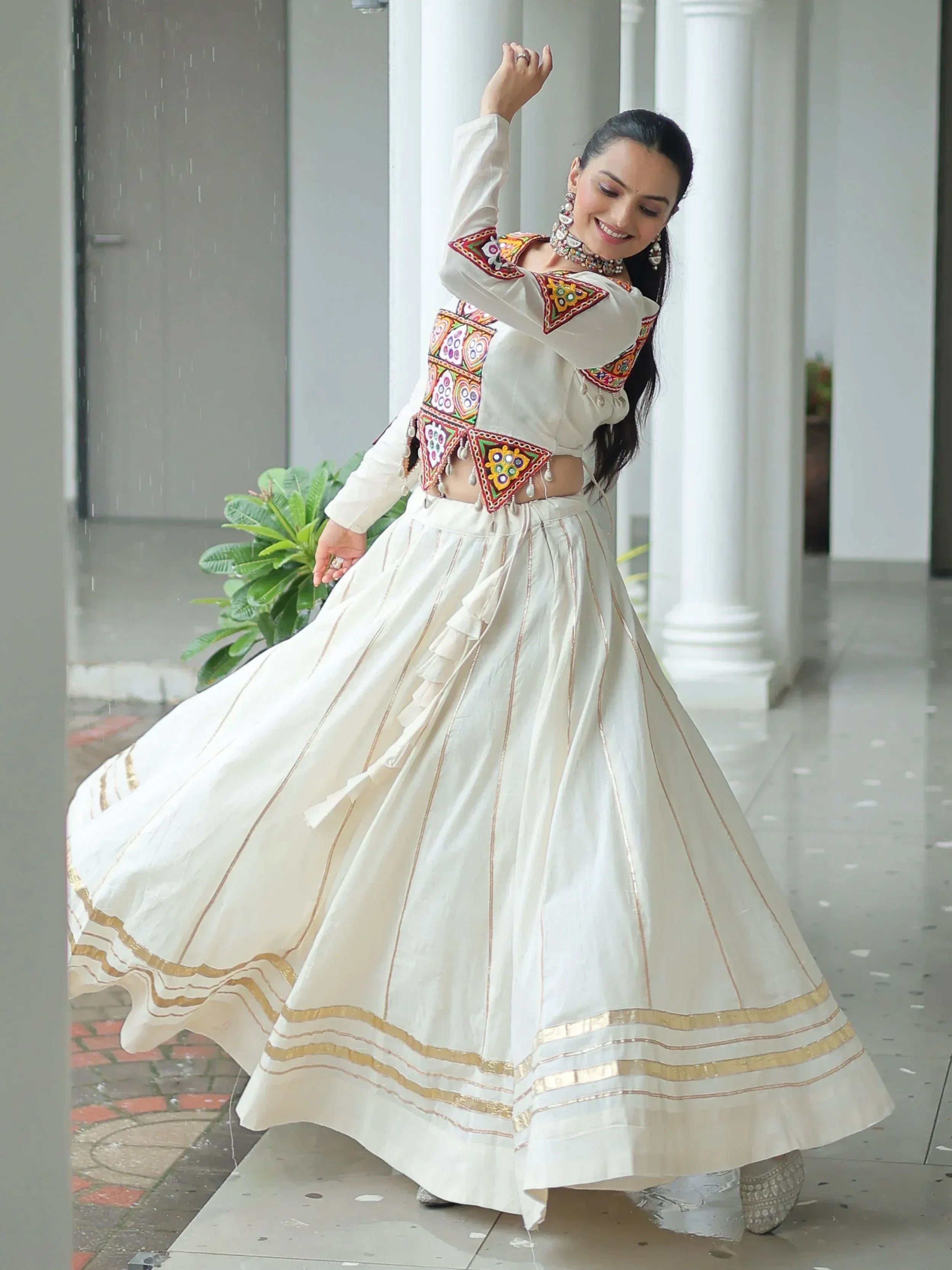 White embroidered lehenga choli with gold trim, perfect for Indian ethnic wear and festive occasions.