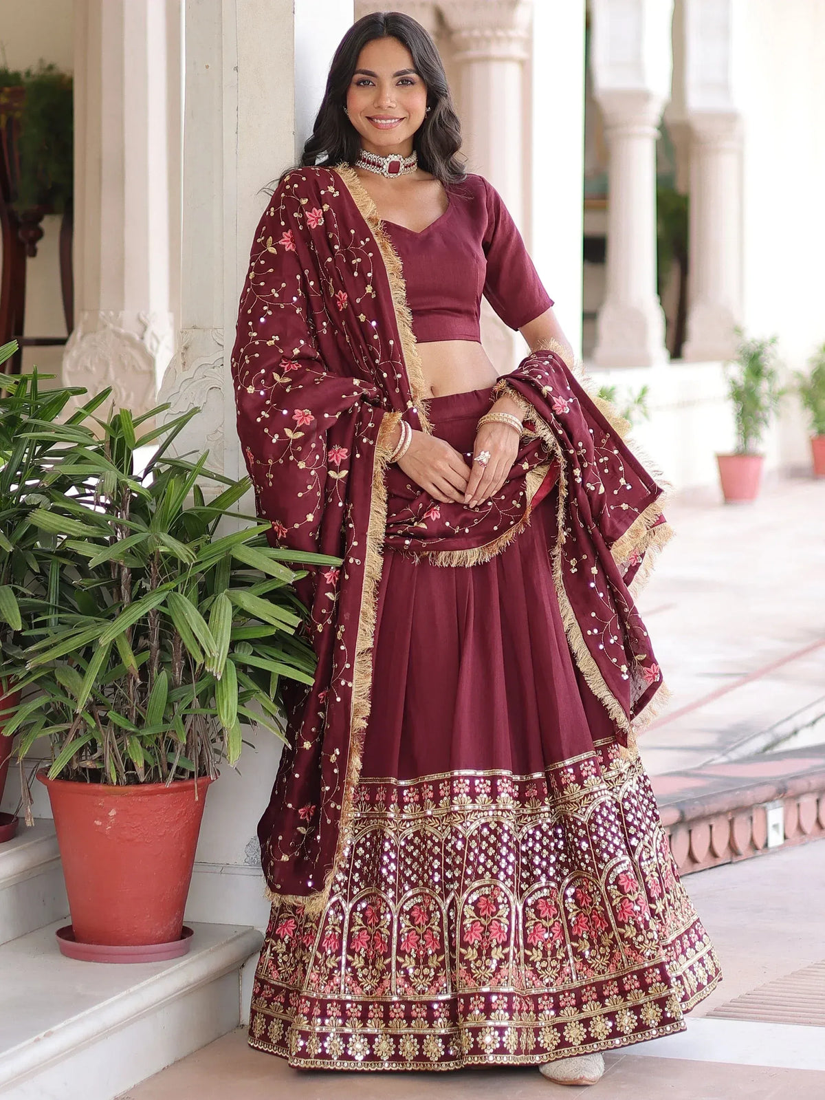 Maroon embroidered lehenga choli with gold detailing, perfect for Indian ethnic wear and festive occasions.