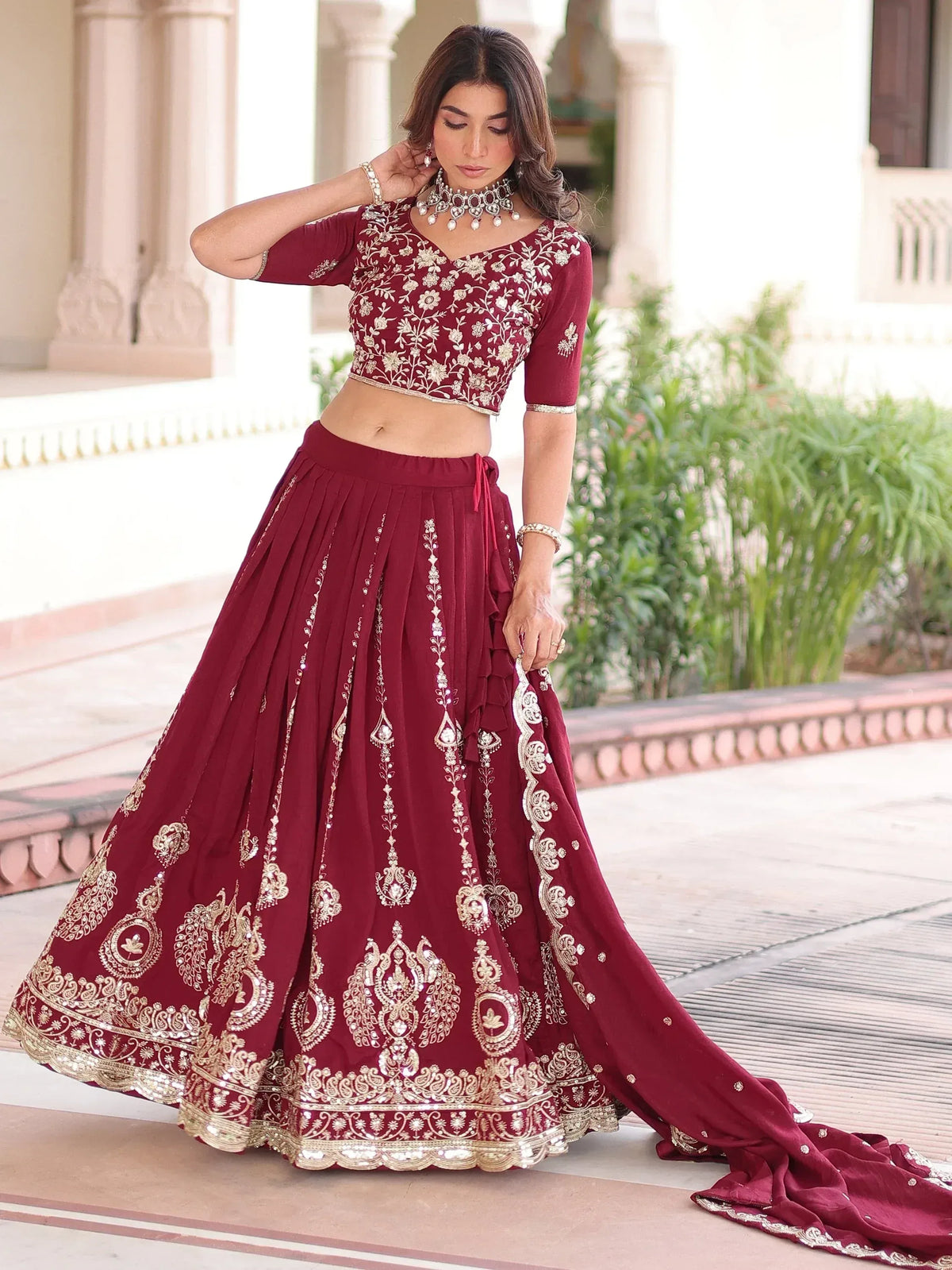 Maroon lehenga choli with gold embroidery, perfect for weddings and festive occasions.