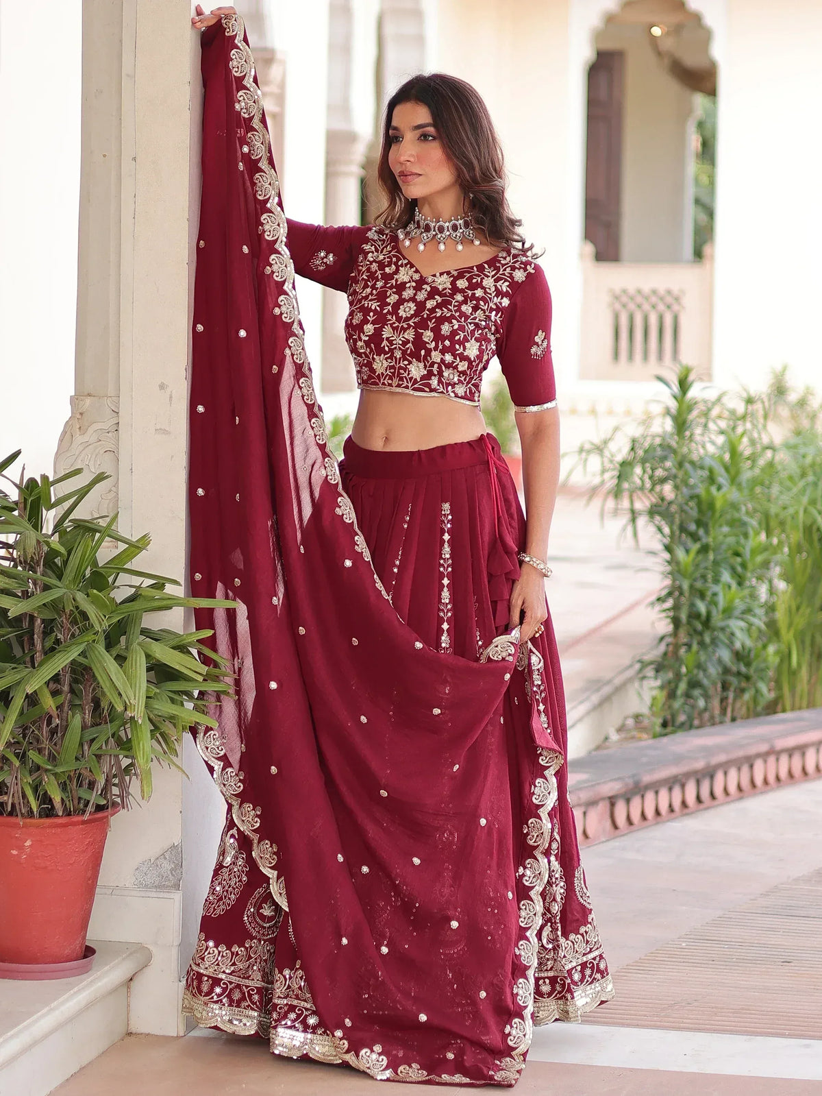 Maroon embroidered lehenga choli with gold detailing, perfect for Indian ethnic wear occasions.