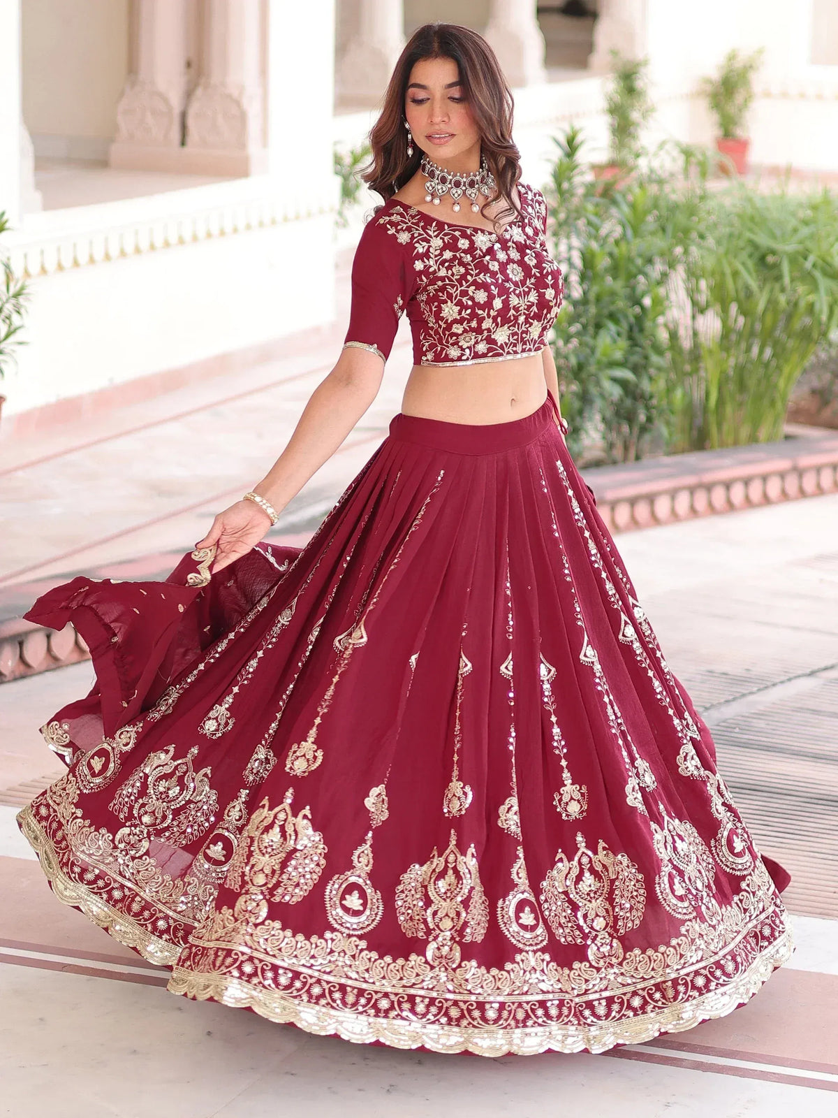 Maroon embroidered lehenga choli with gold detailing, perfect for Indian ethnic wear occasions.