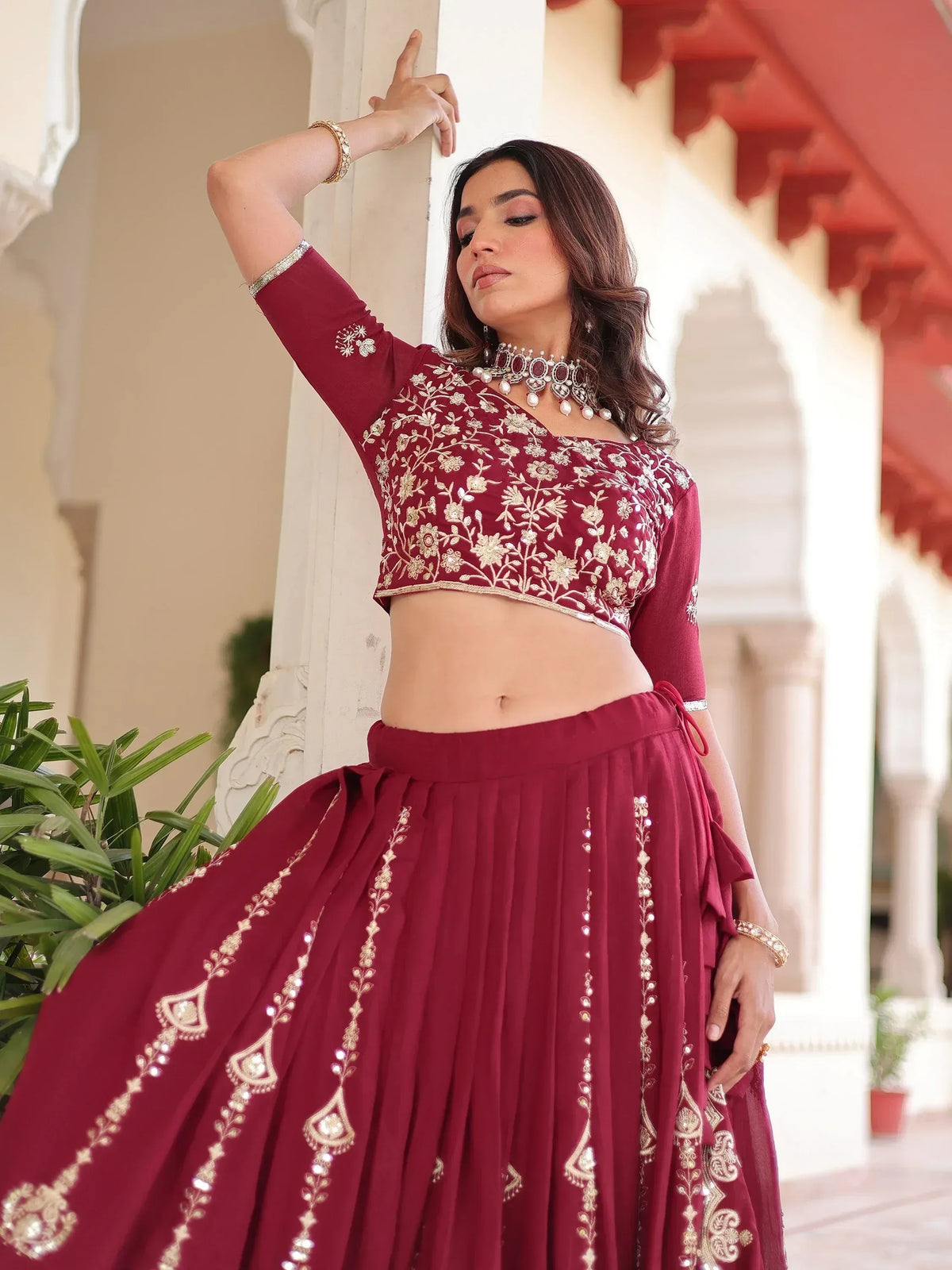 Maroon embroidered lehenga choli with gold floral work, perfect for Indian ethnic wear and festive occasions.