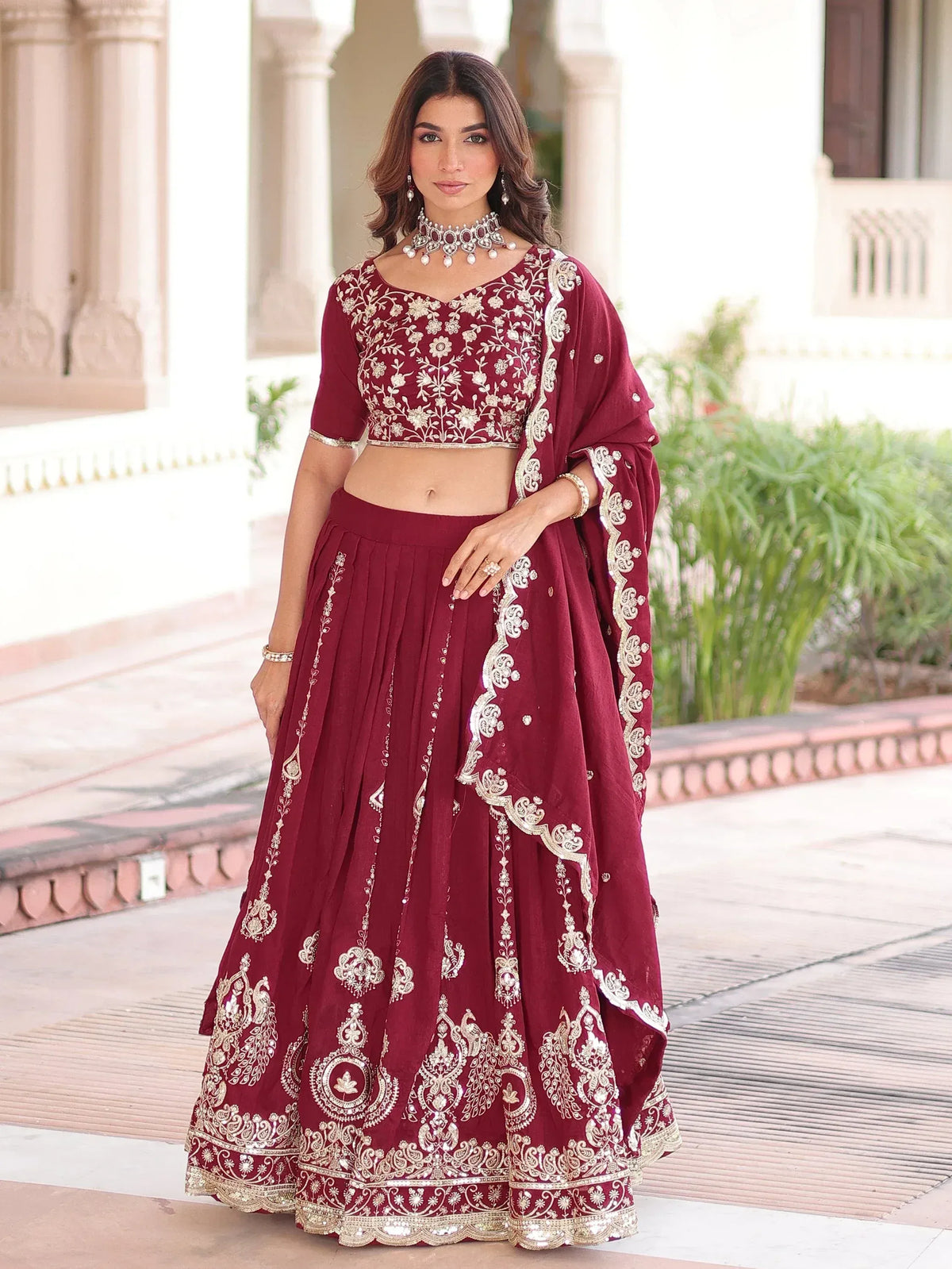 Maroon embroidered lehenga choli with gold detailing, perfect for Indian ethnic wear occasions.