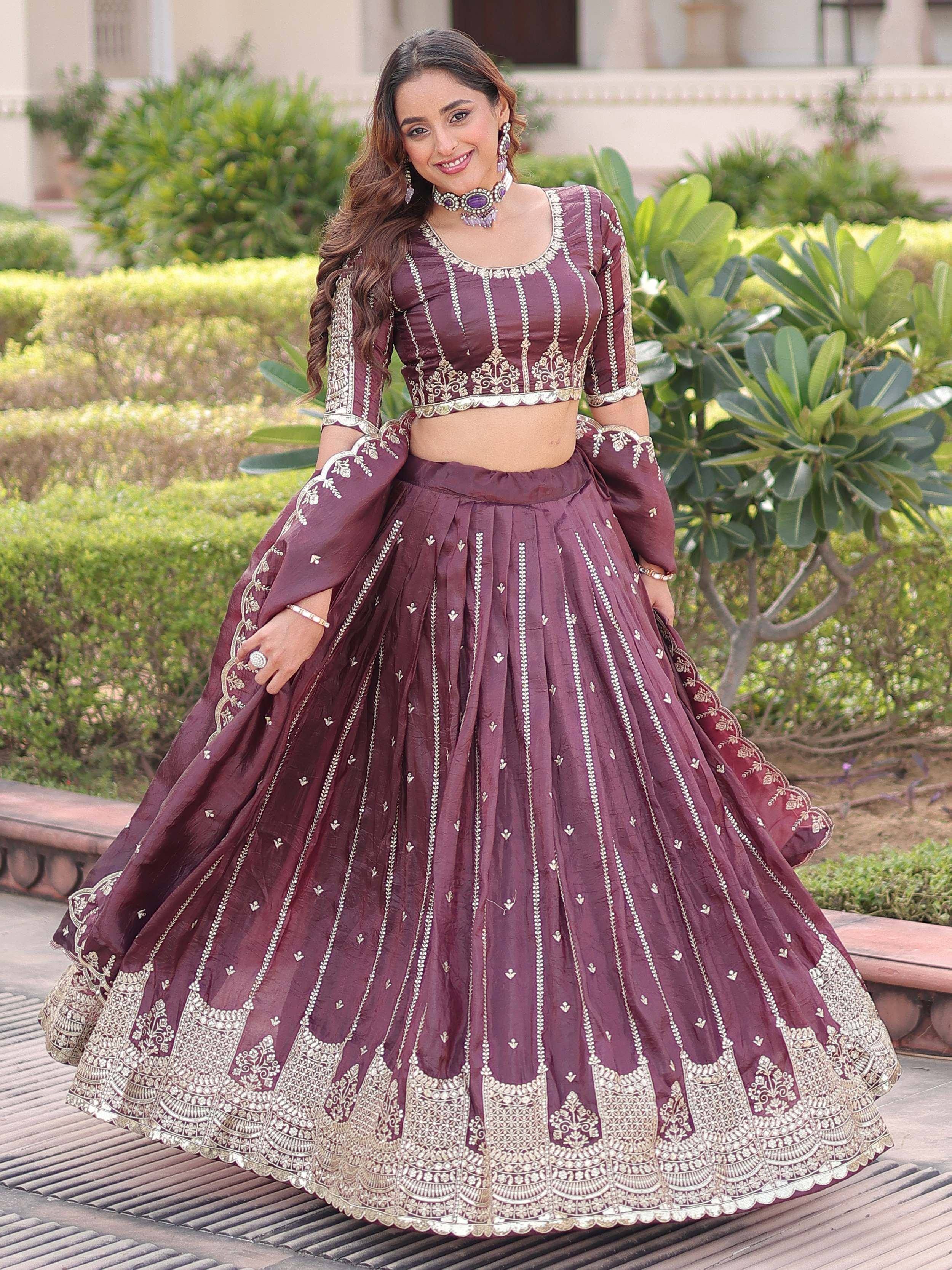 Elegant maroon lehenga choli with intricate gold embroidery, perfect for Indian weddings and festive occasions.