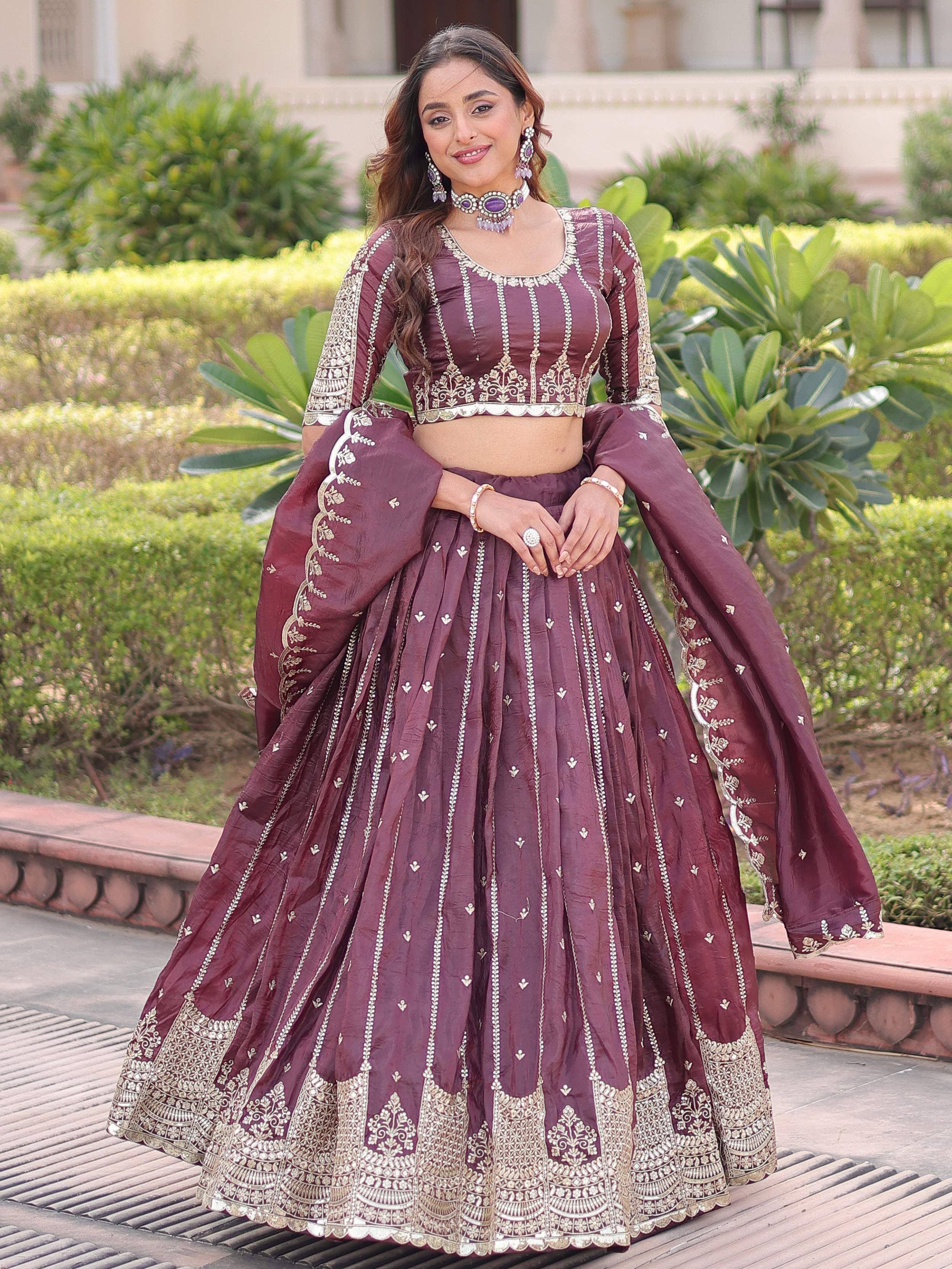 Burgundy embroidered lehenga choli with gold detailing, perfect for Indian weddings and festive occasions.