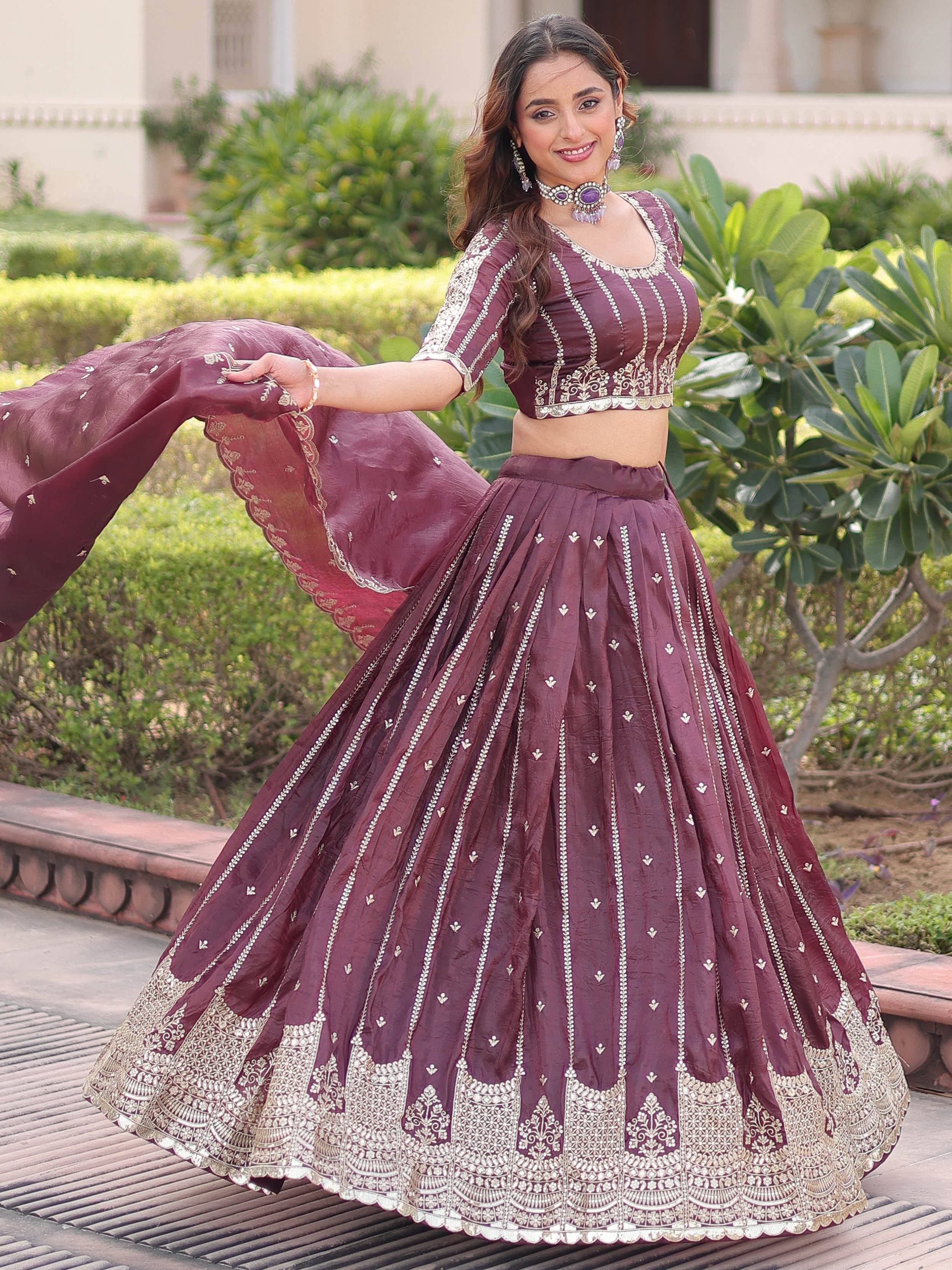 Burgundy designer lehenga choli with gold embroidery, perfect for Indian weddings and festive occasions