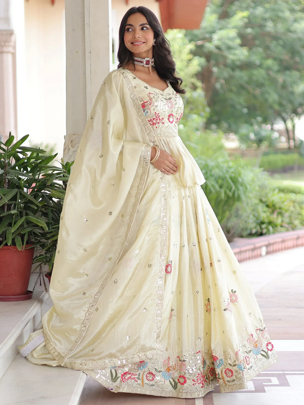 Elegant cream lehenga choli with floral embroidery and mirror work, perfect for Indian ethnic wear.