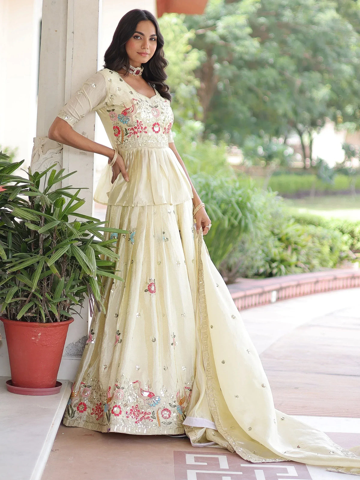 Cream embroidered lehenga choli with peacock motifs, floral designs, and sequin detailing for Indian ethnic wear