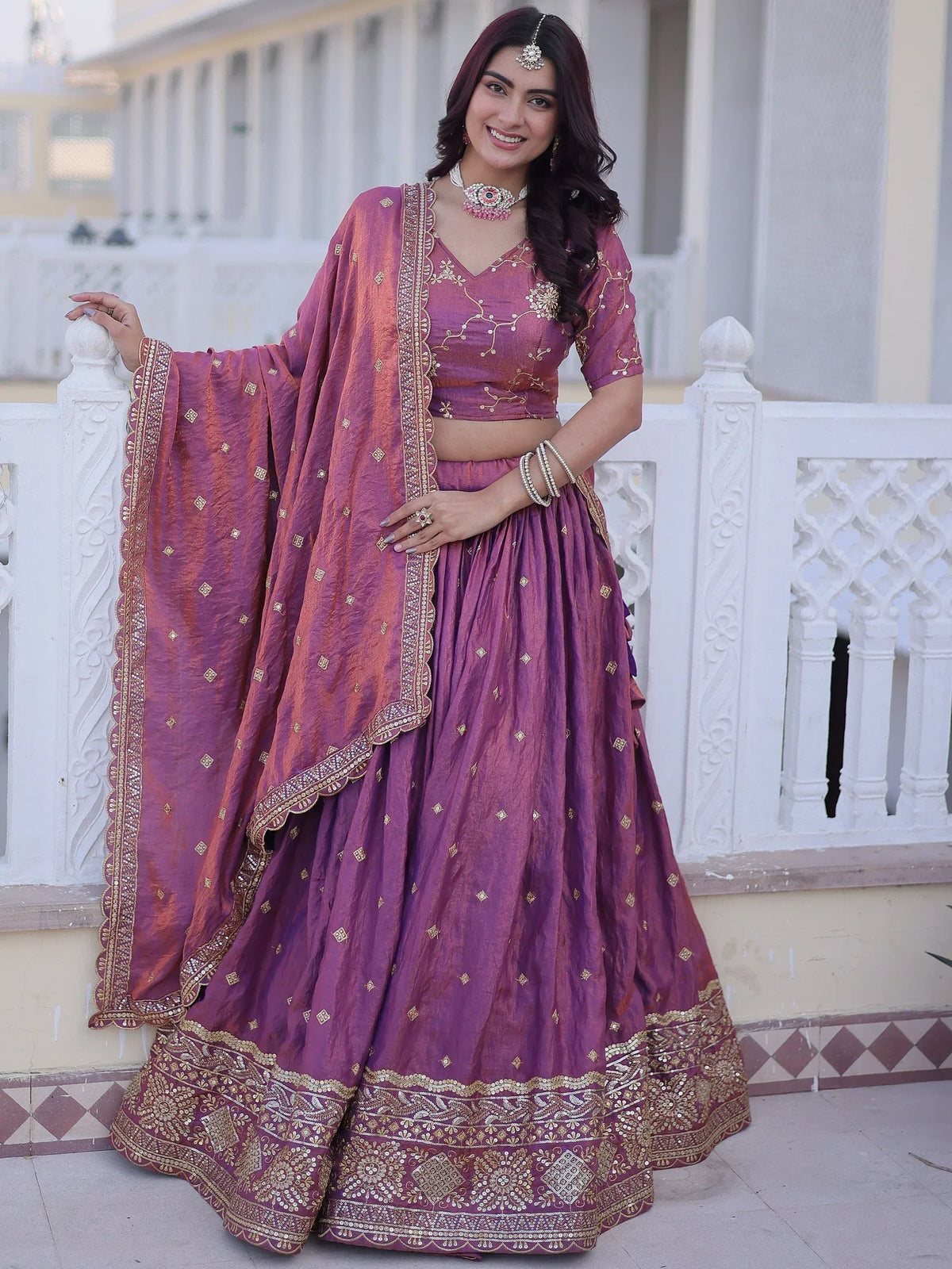 Purple designer lehenga choli with gold embroidery, perfect for Indian weddings and festive occasions