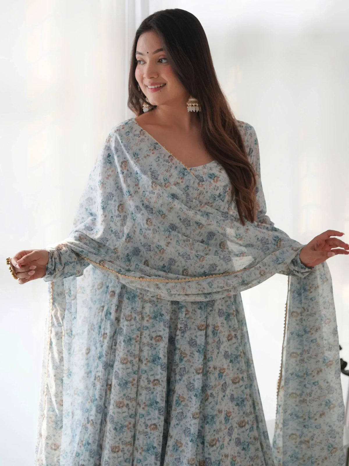 Floral print ethnic gown with draped neckline and gold trim, perfect for Indian occasions.