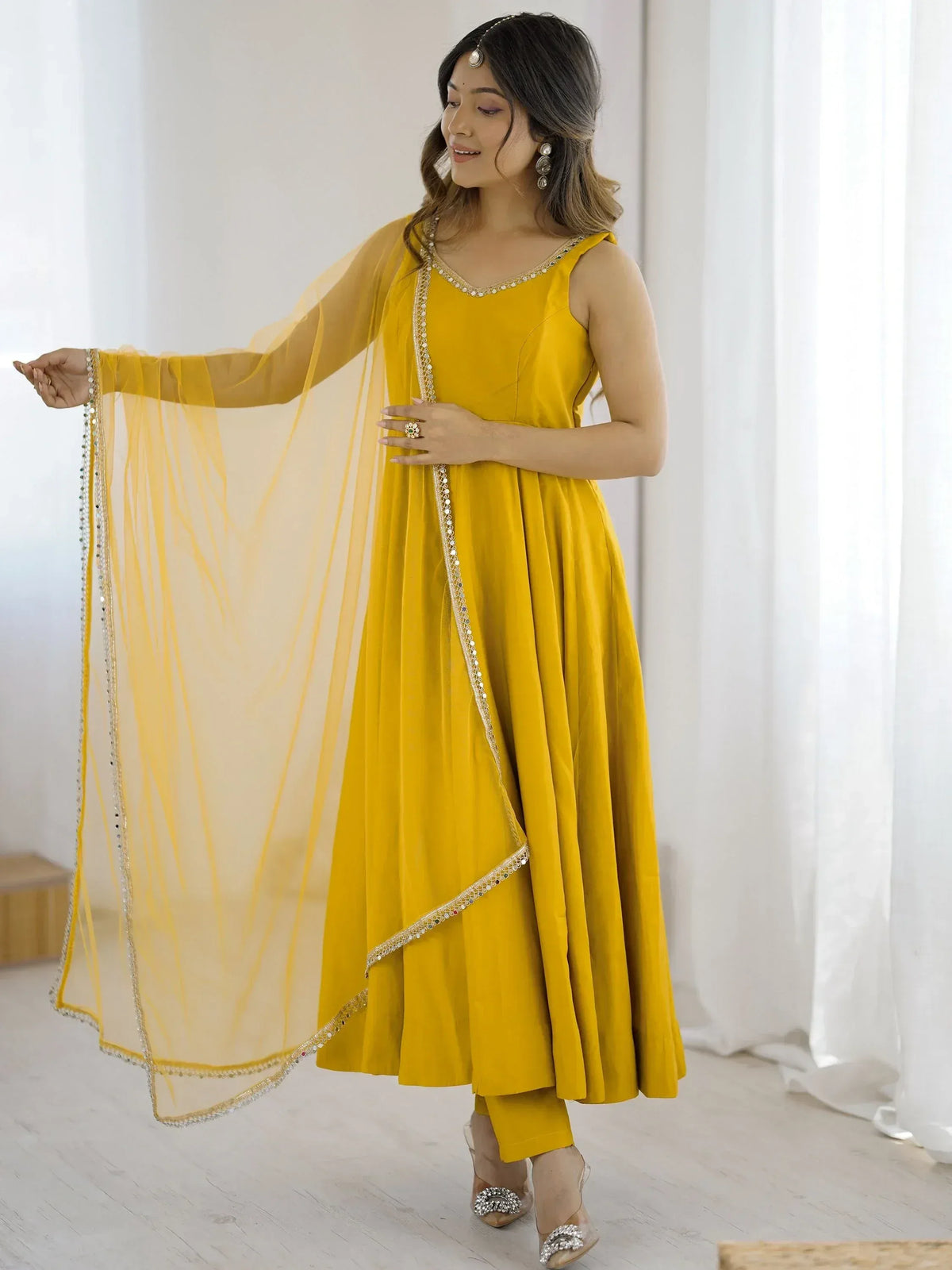 Yellow ethnic gown with sequin detailing and matching dupatta for festive occasions