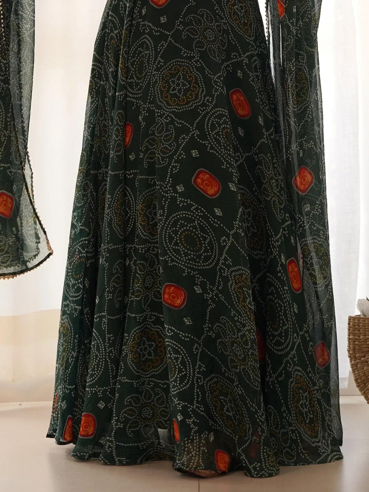 Green ethnic gown with intricate paisley and floral patterns, perfect for Indian festive wear