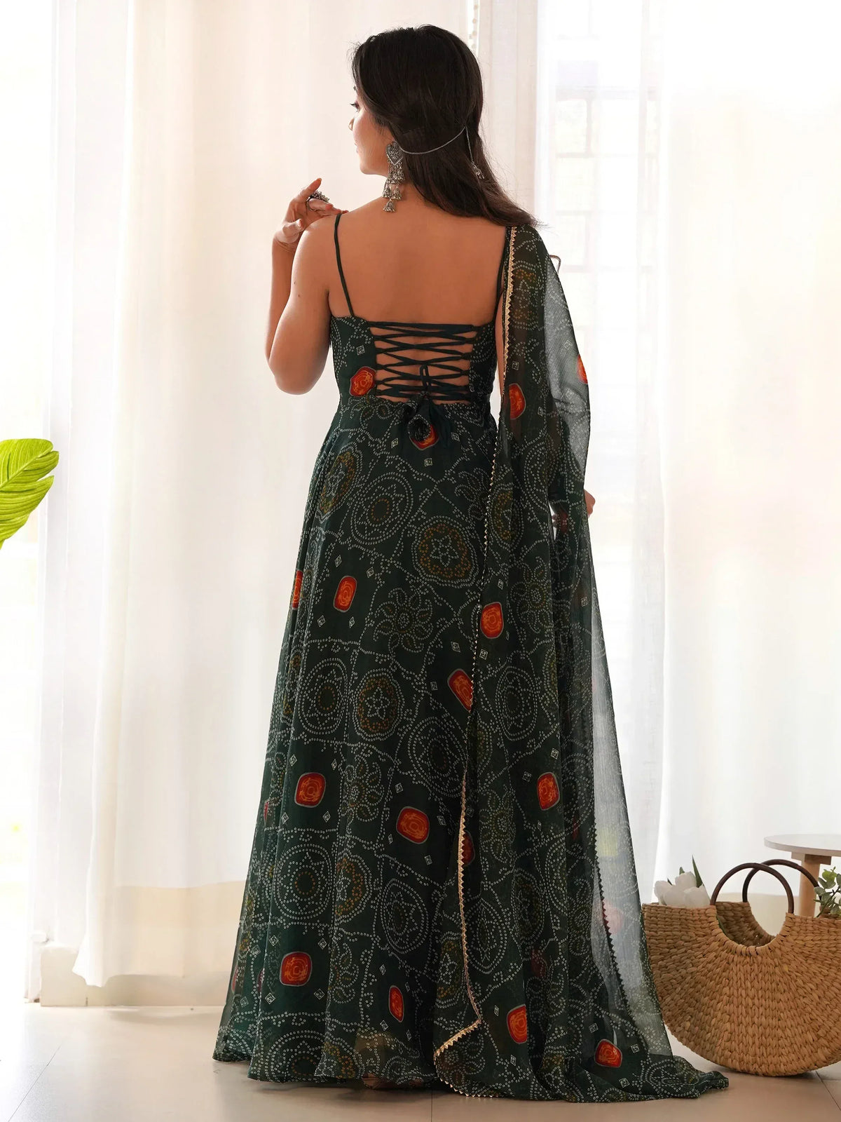 Green printed ethnic gown with lace-up back and sheer dupatta, perfect for Indian occasions.