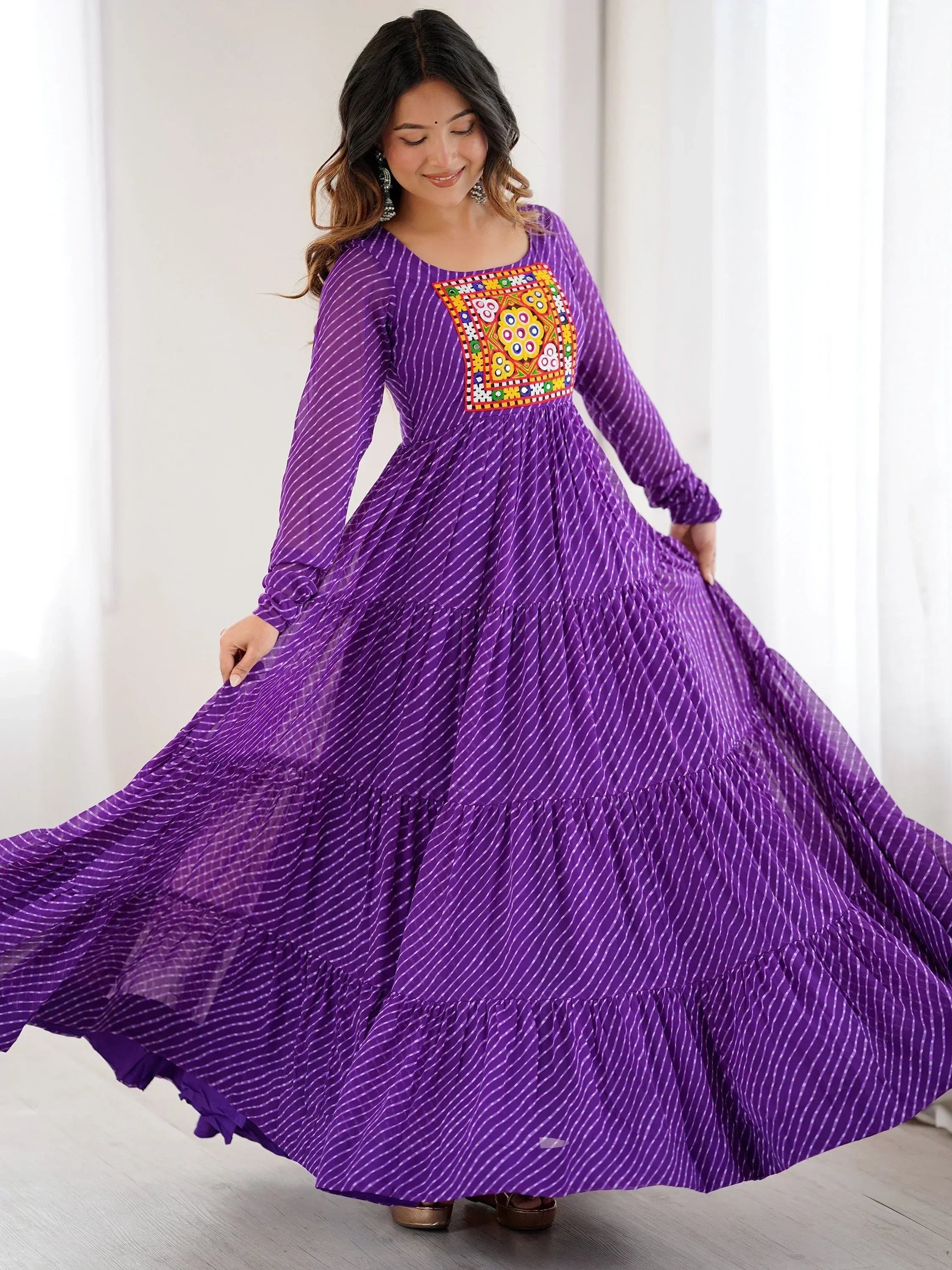 Purple ethnic gown with colorful embroidery, long sleeves, and tiered skirt for women