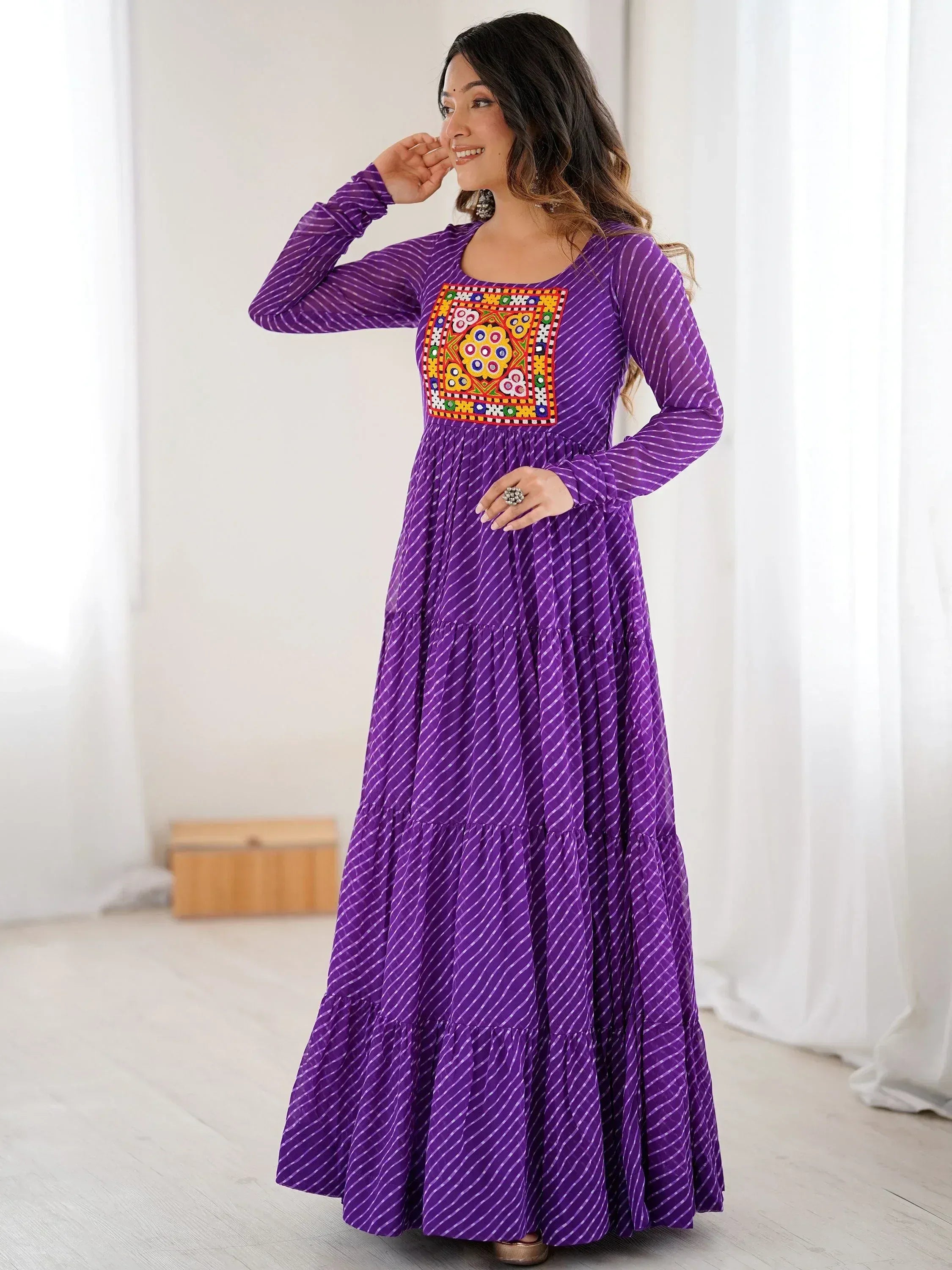 Purple ethnic gown with colorful embroidered panel, long sleeves, and tiered skirt for women